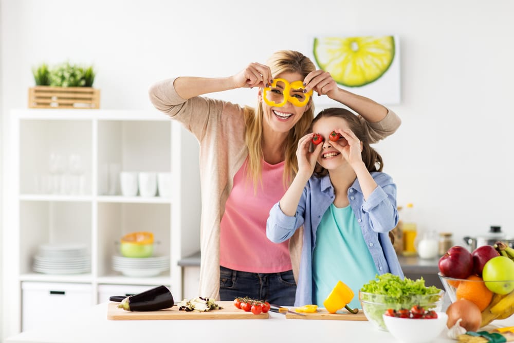 Family laughing in the kitchen.