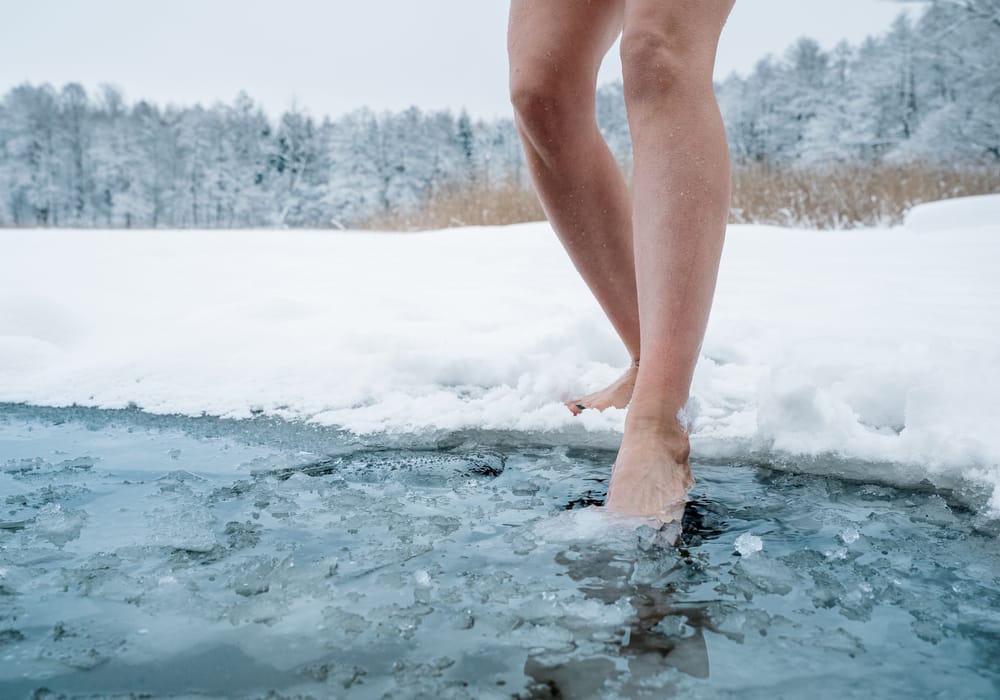 Female legs walking in water.