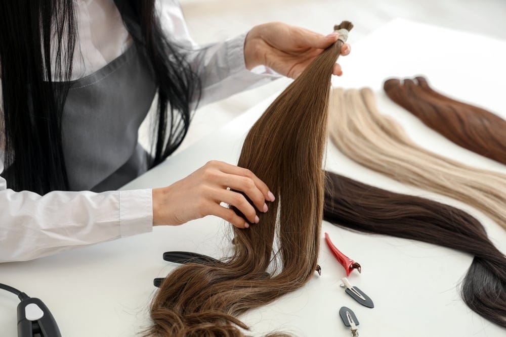 Female hairdresser with hair extensions. 