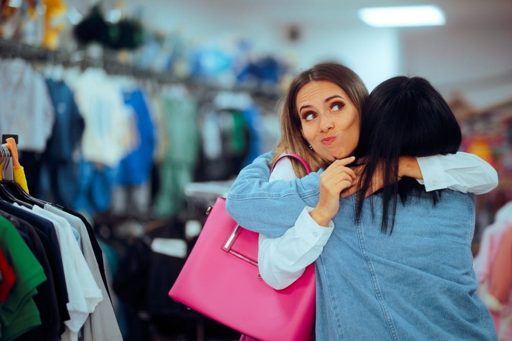 One woman giving another woman a fake hug.
