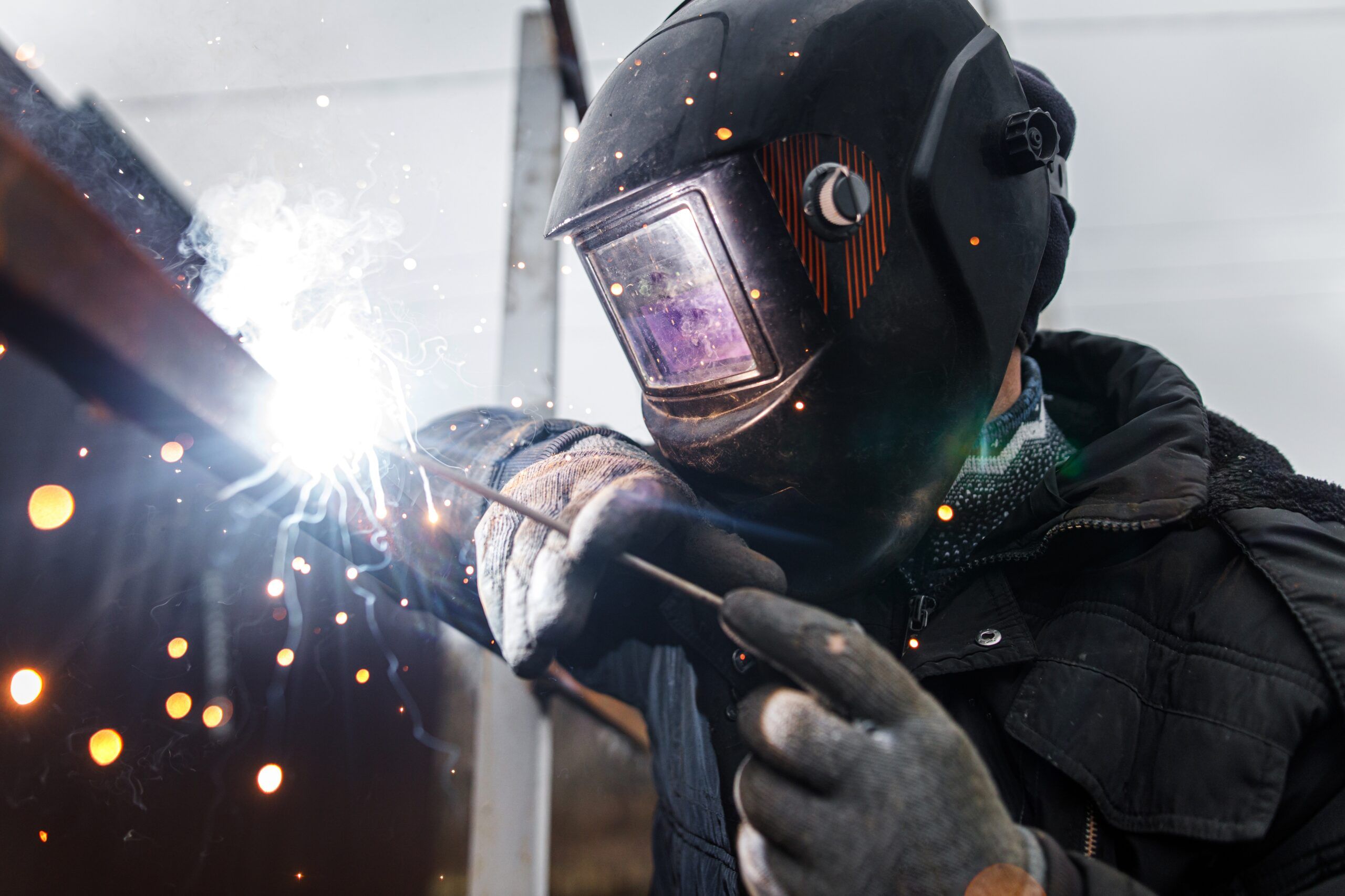 Man using a welding rod.