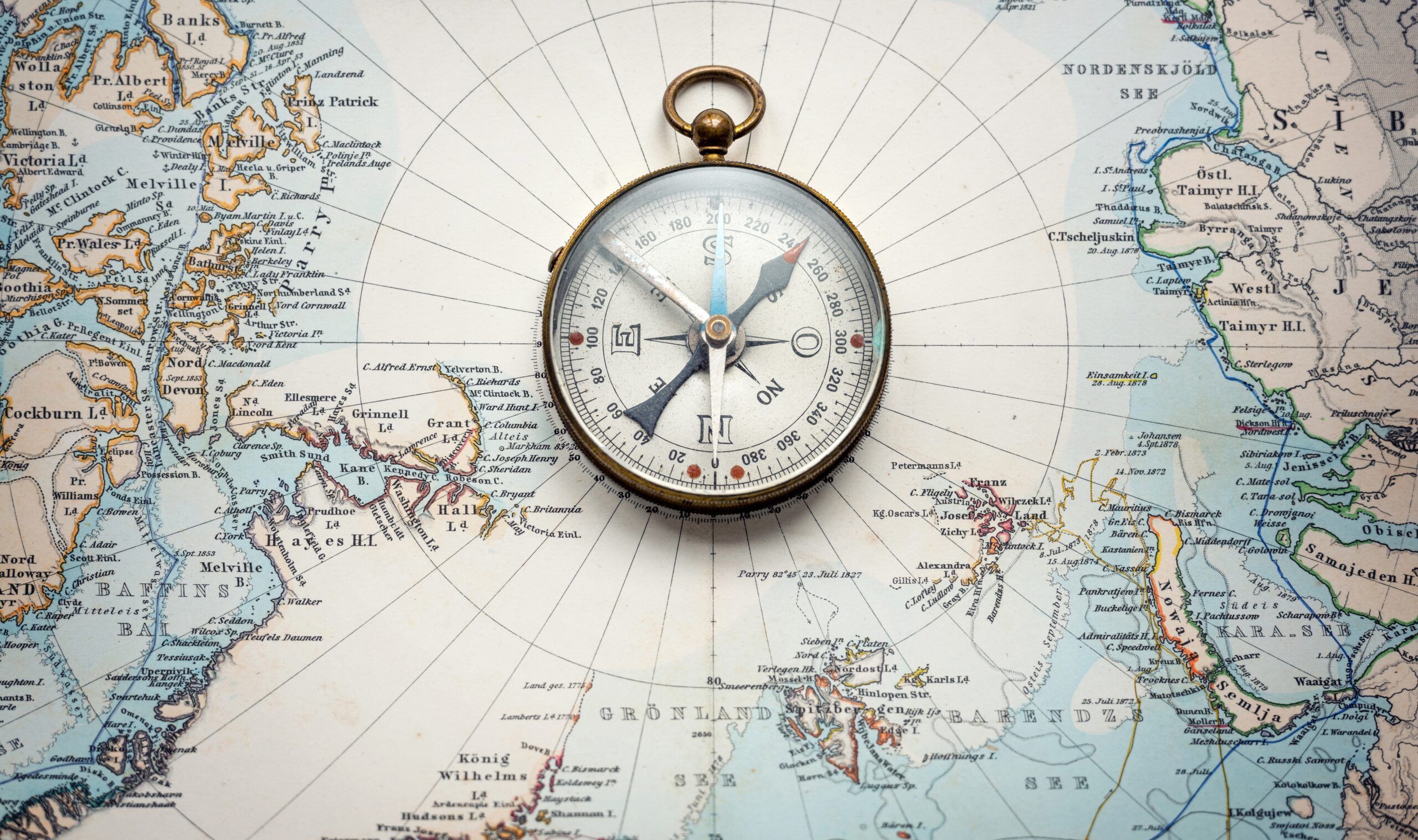 Compass lying on a map.