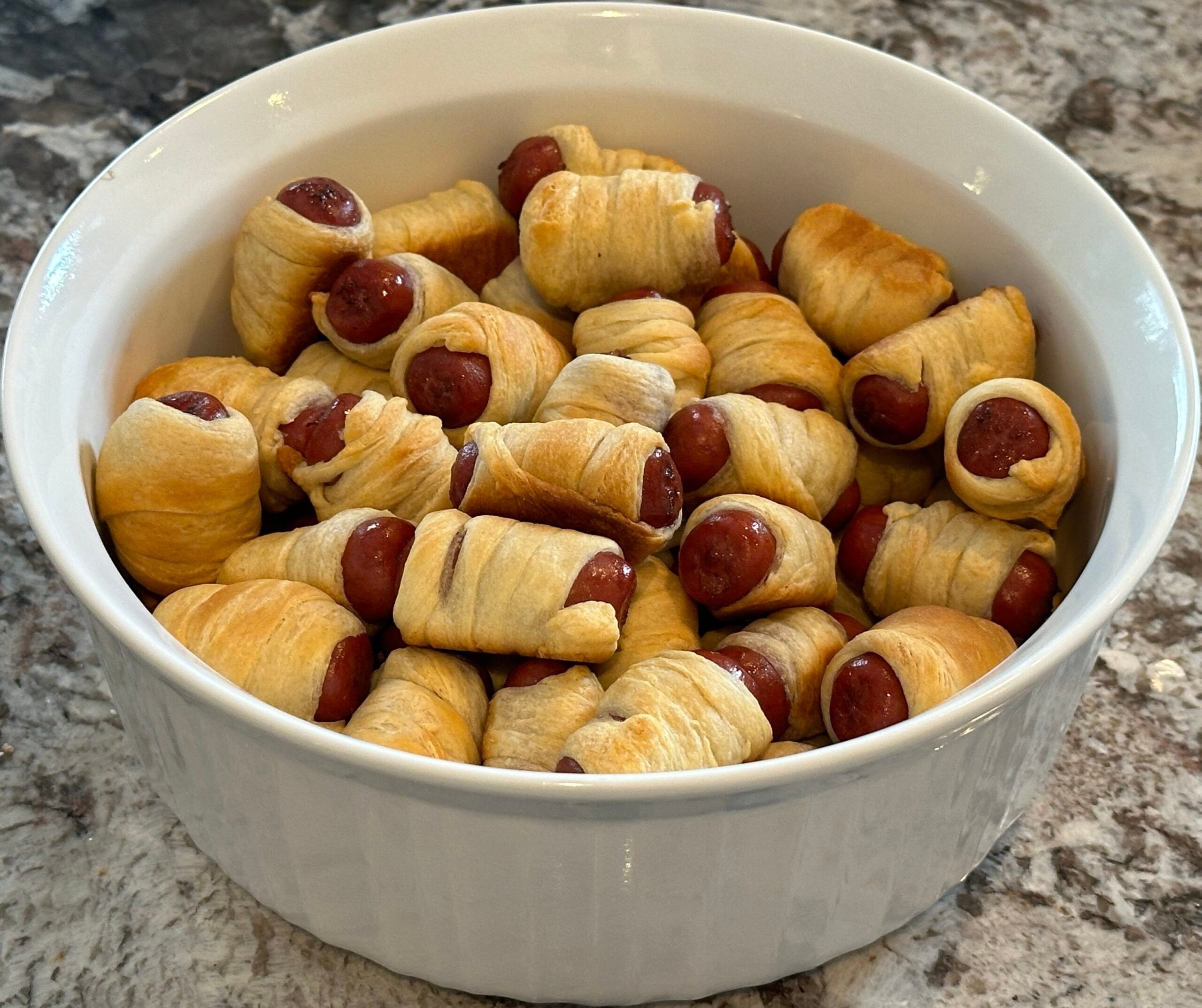 A bowl of pigs in a blanket.