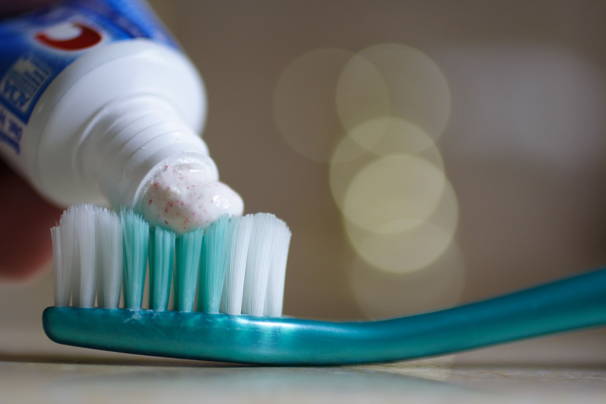 Toothpaste on a tooth brush.