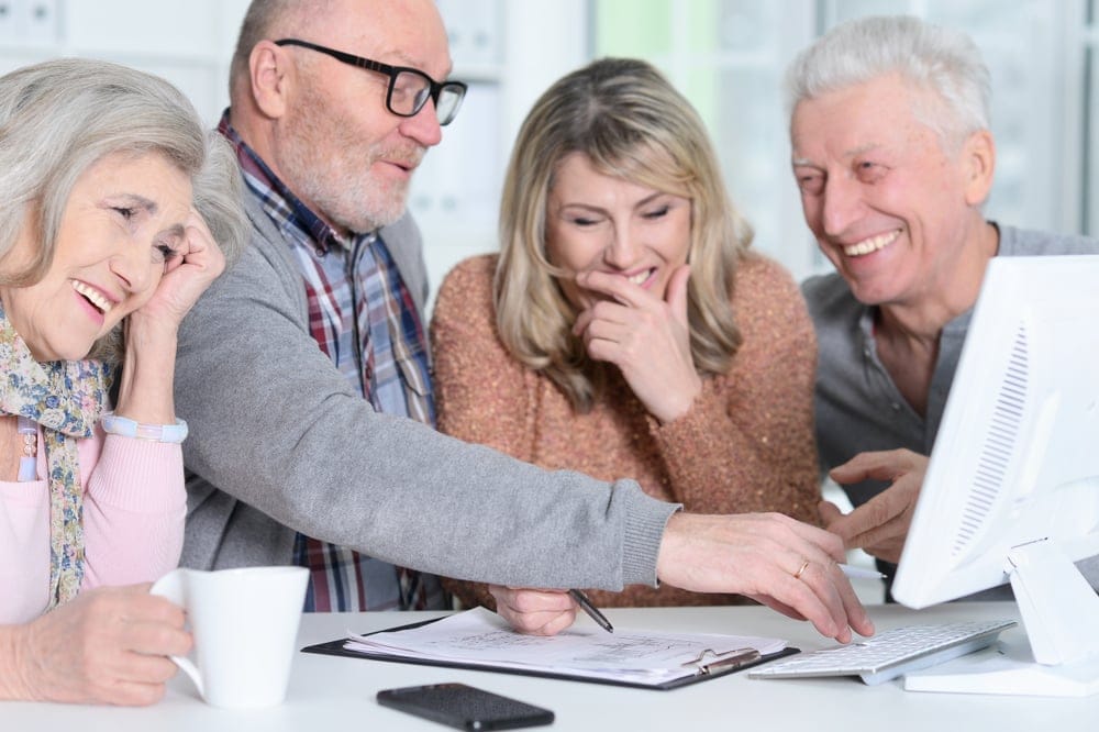 Two set of senior couples having fun and laughing together