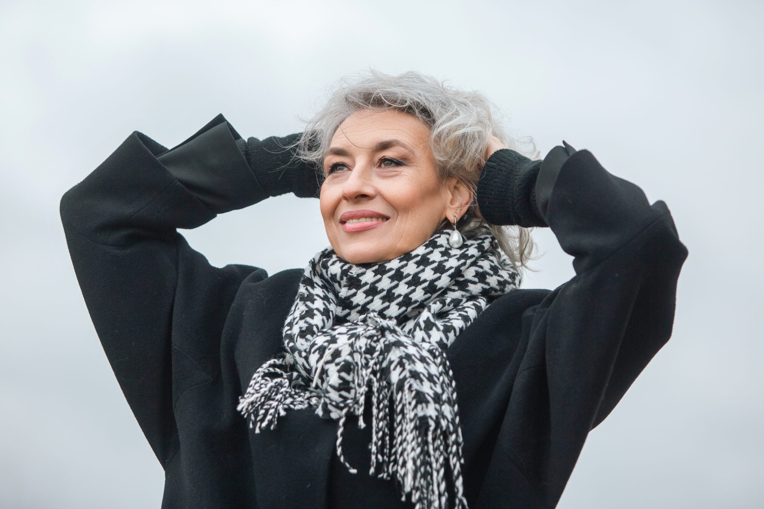 Mature woman with gray hair who embraces aging.