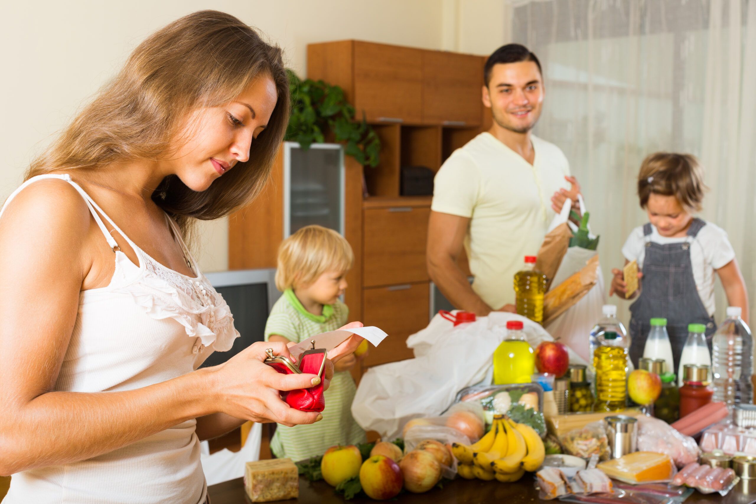 Low income family checking the receipt of their recent grocery bill.
