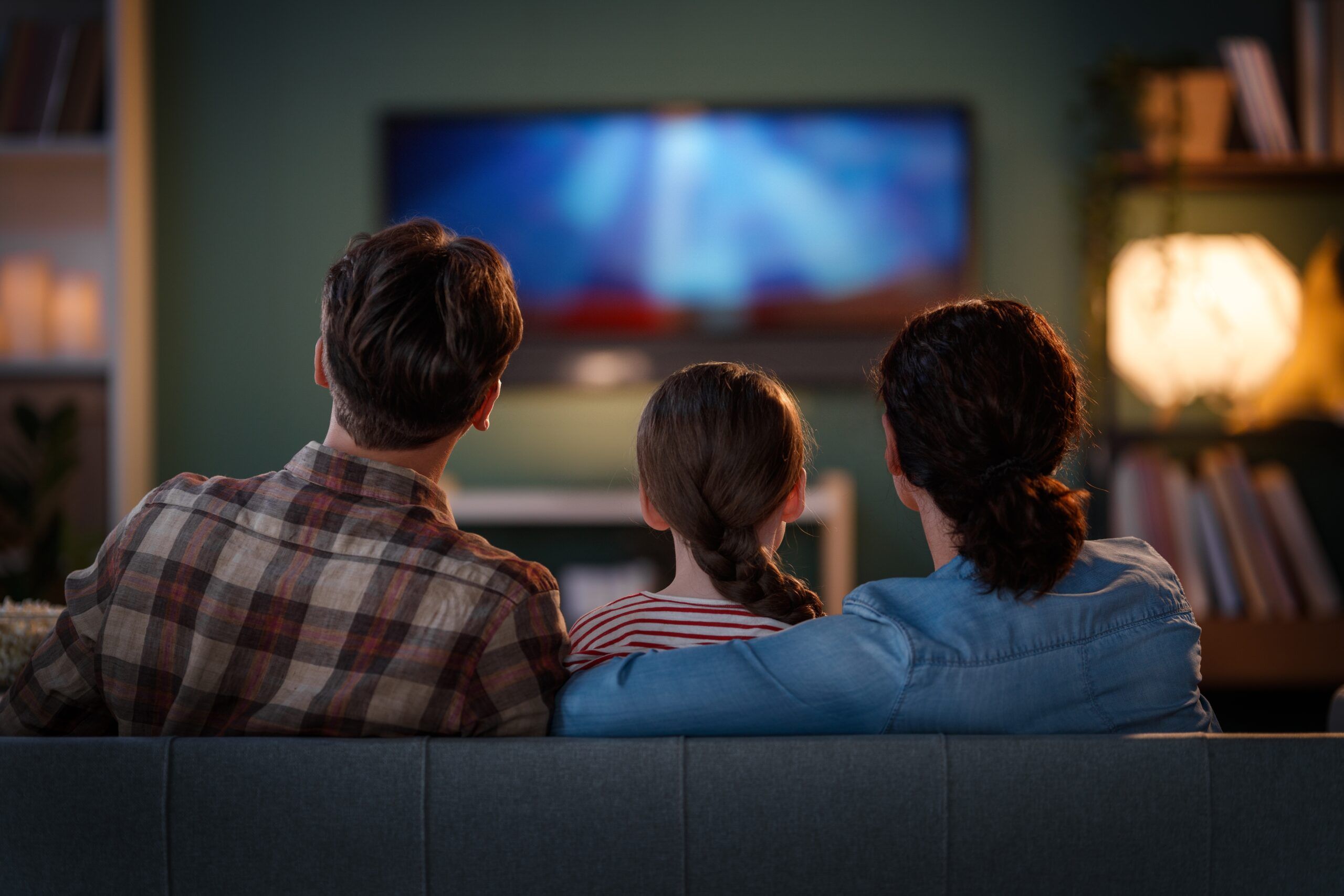 Average American family watching TV together.