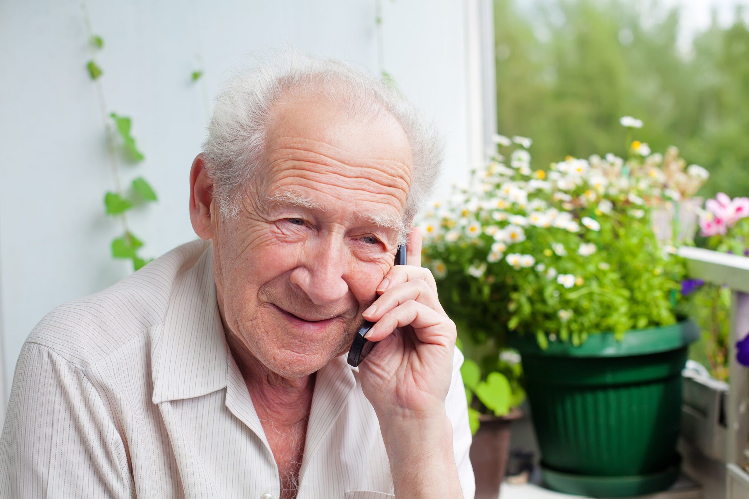 Mature gentleman speaking to family on the phone.
