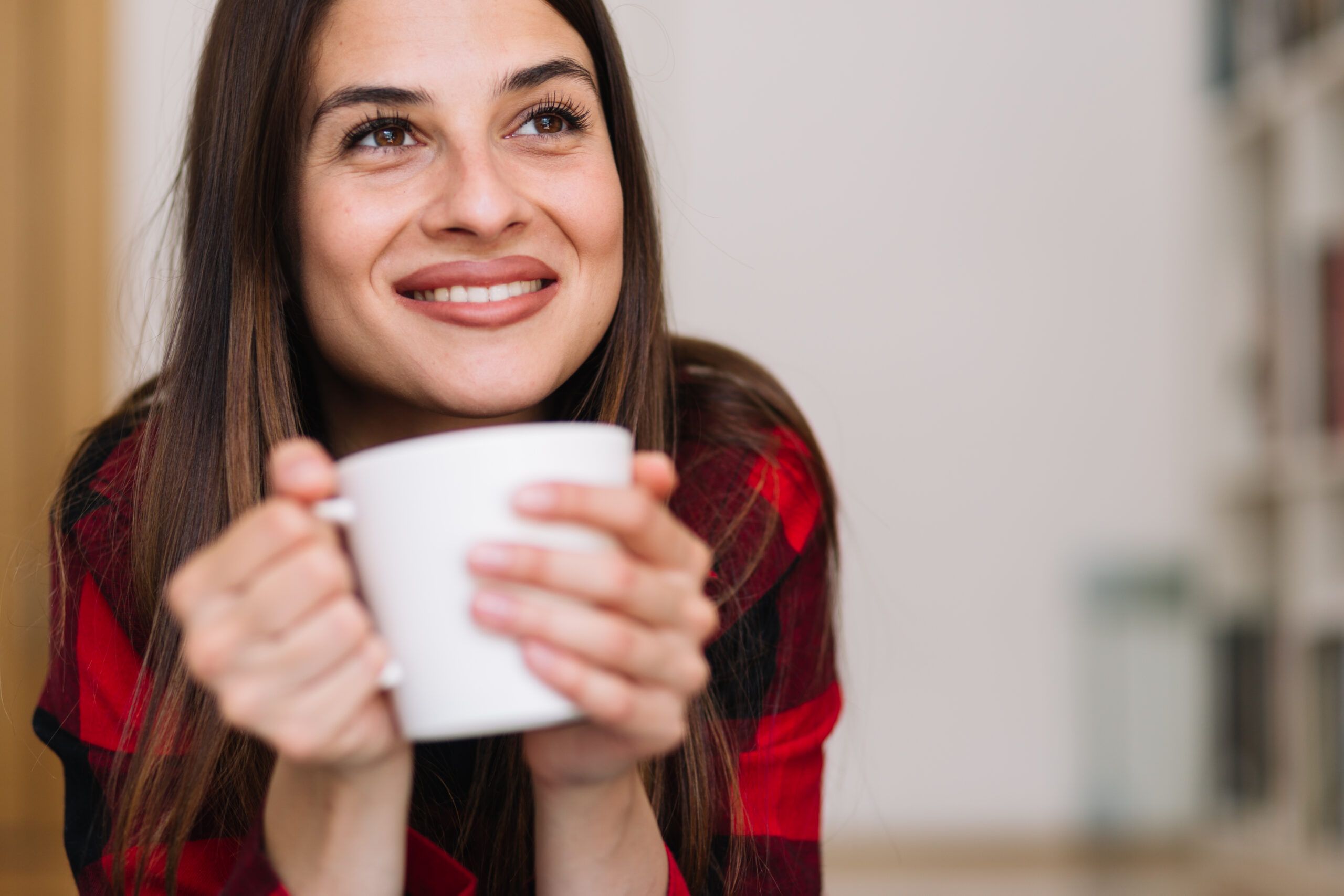 A woman enjoying time alone with a cup of tea.