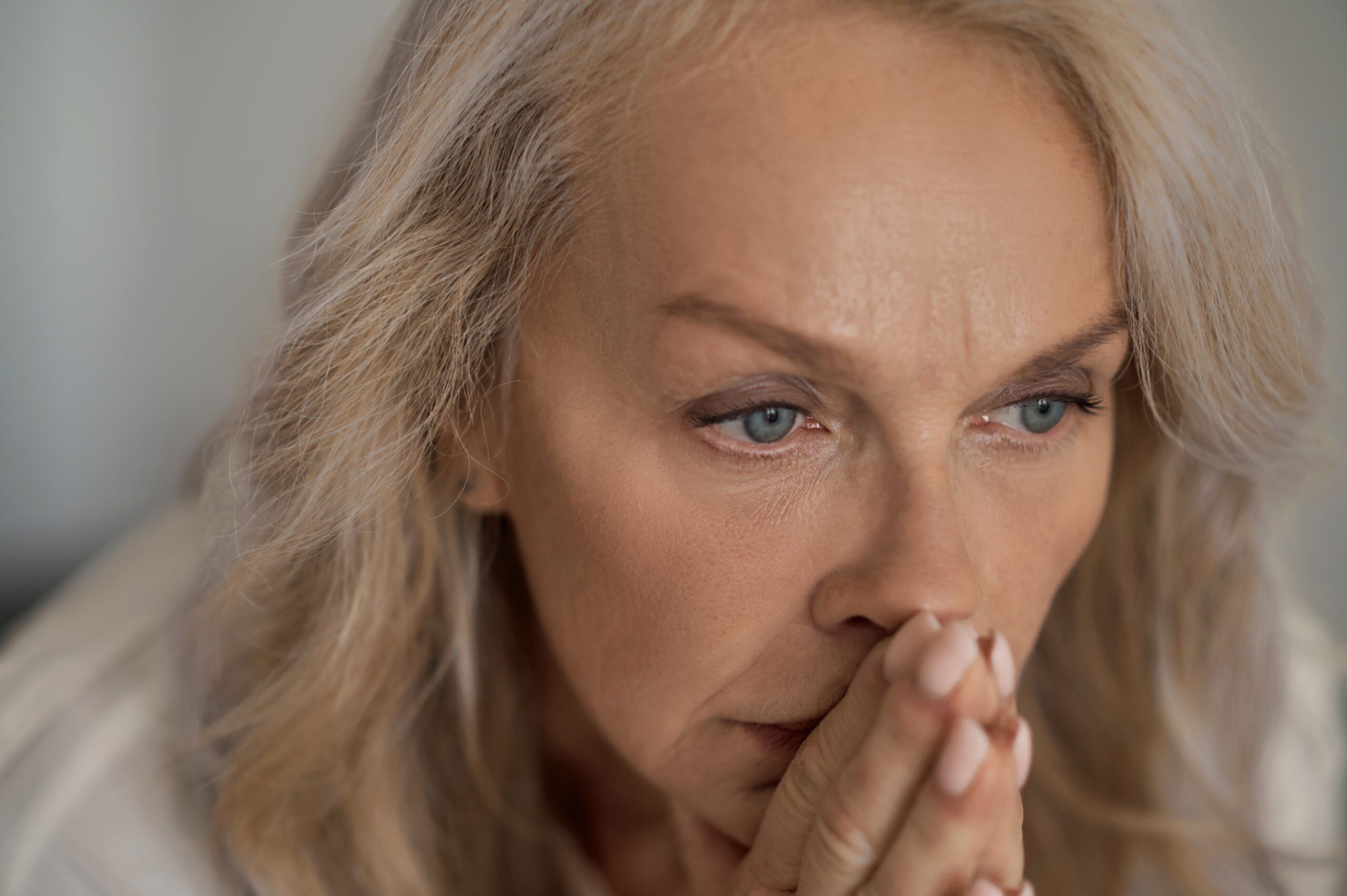 Mature female pondering over her loneliness.