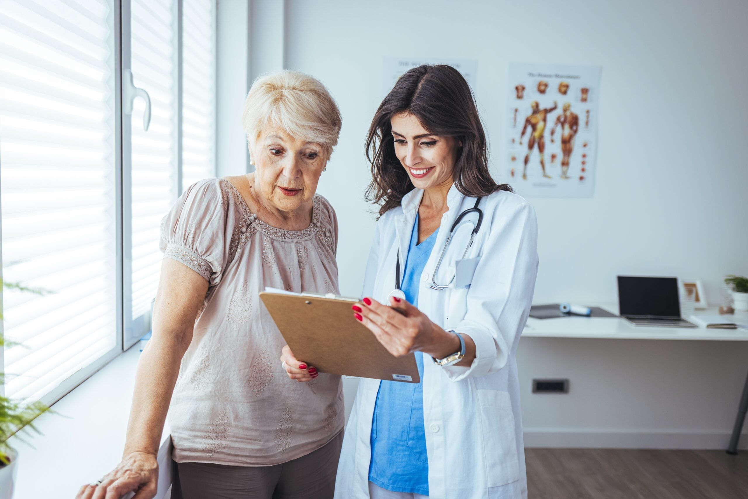 A senior woman speaks with her doctor during a routine check-up.