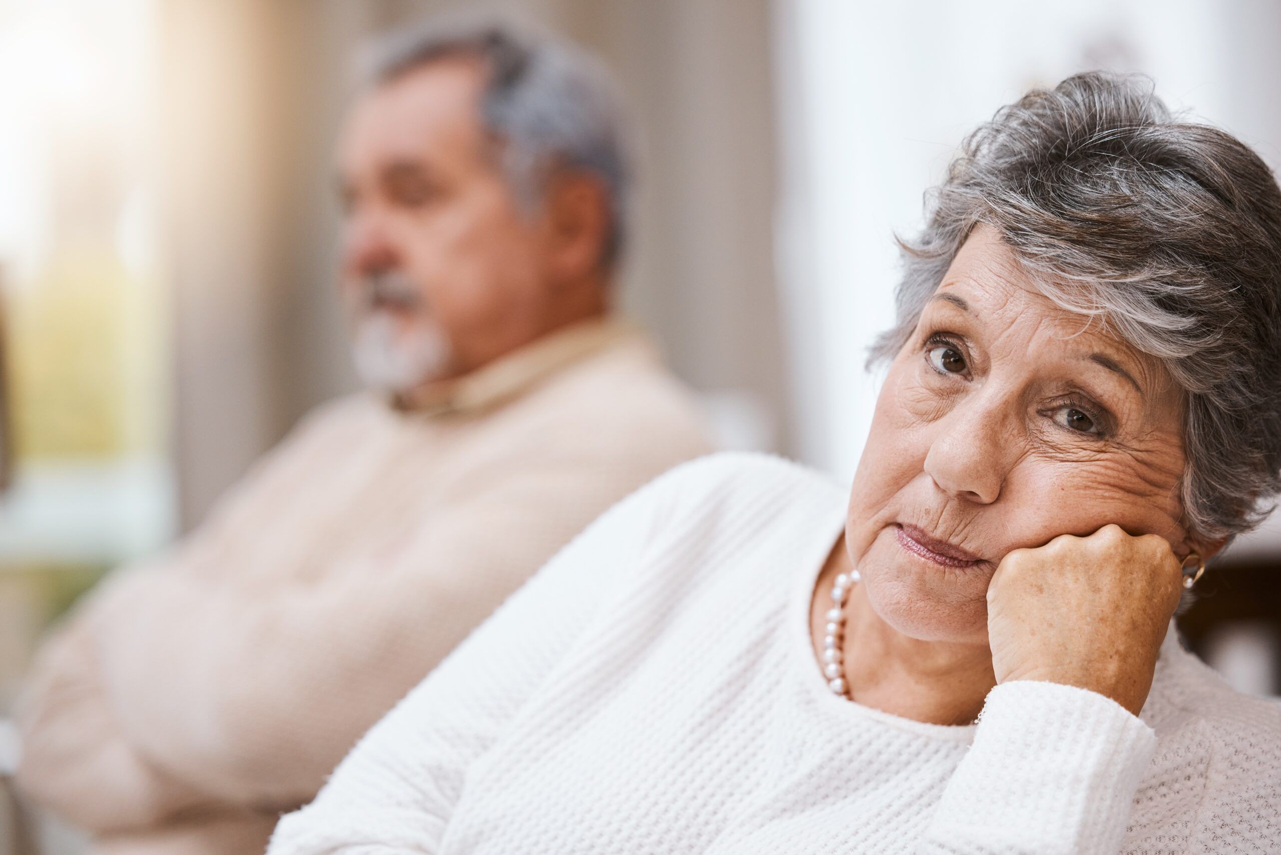 A senior couple sitting at home during a difficult conversation.