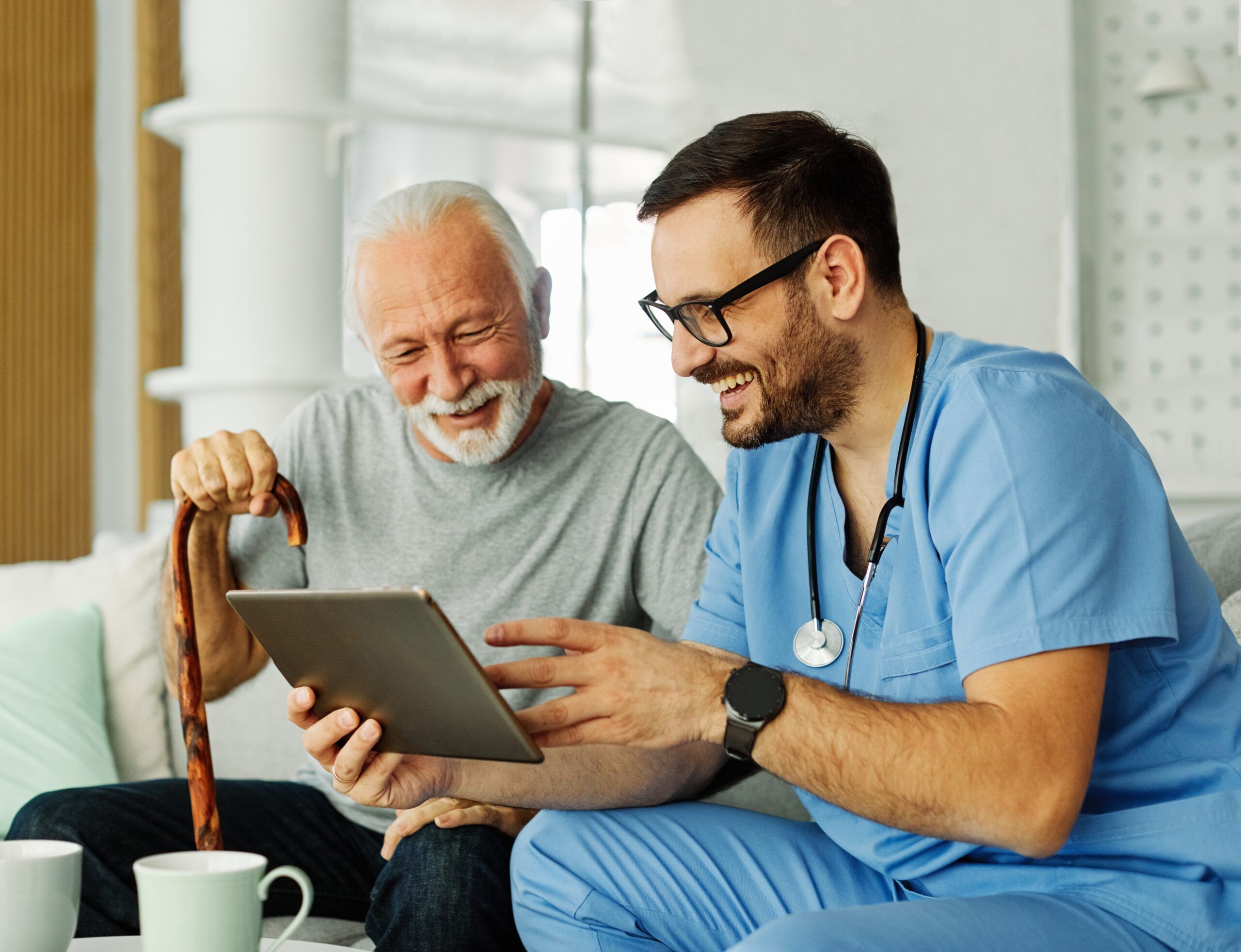 A senior patient laughing with his doctor.