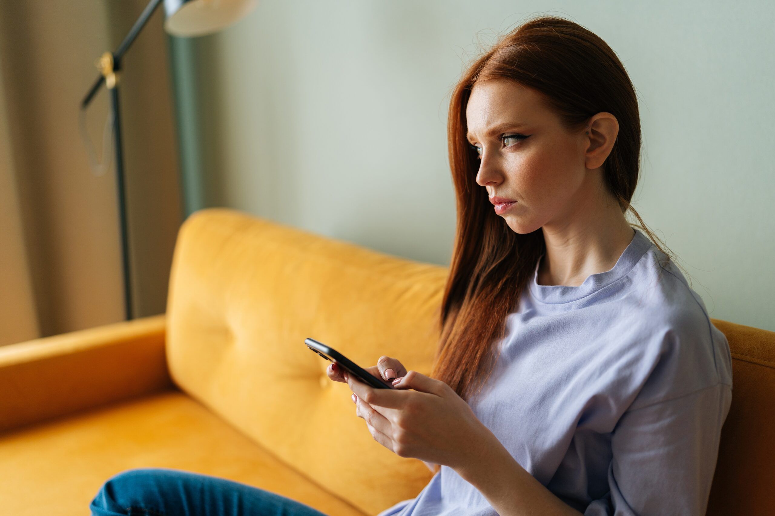 A woman sitting alone happy to have her planned cancelled.