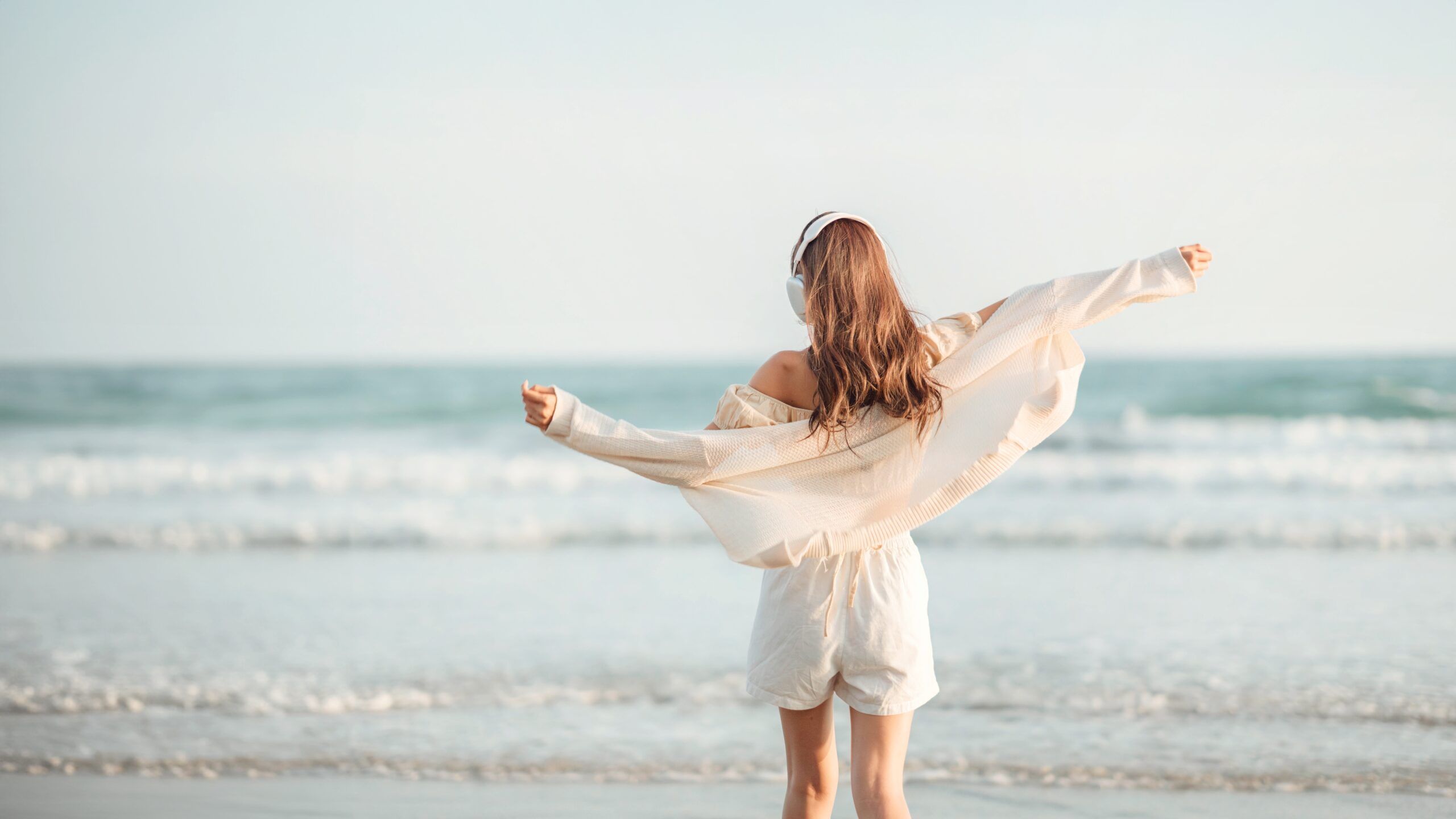 A women enjoying a solo beach walk.