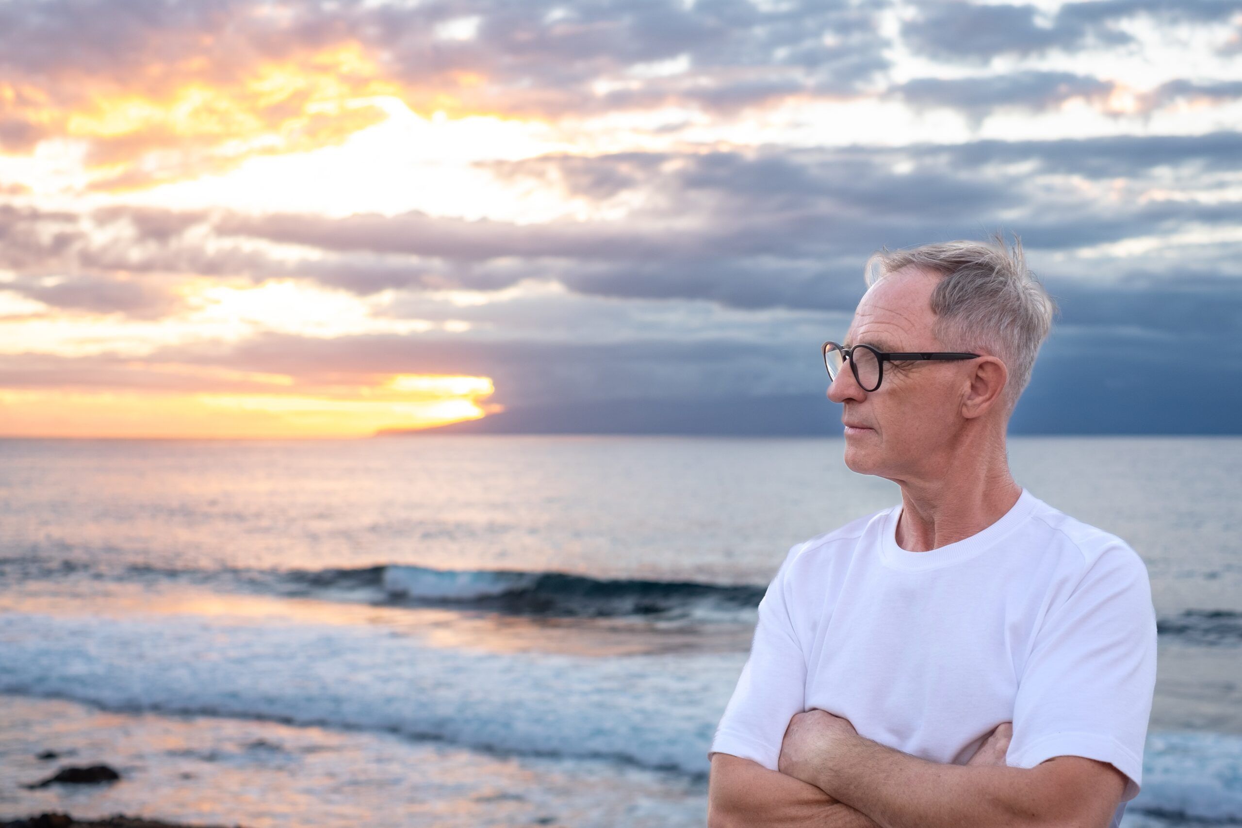 A retired man out for a walk on the ocean.