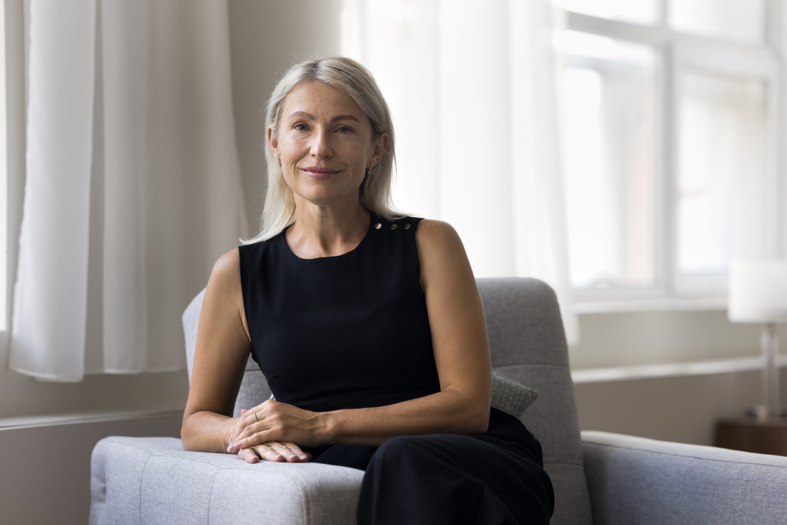 Confident woman sitting on couch.