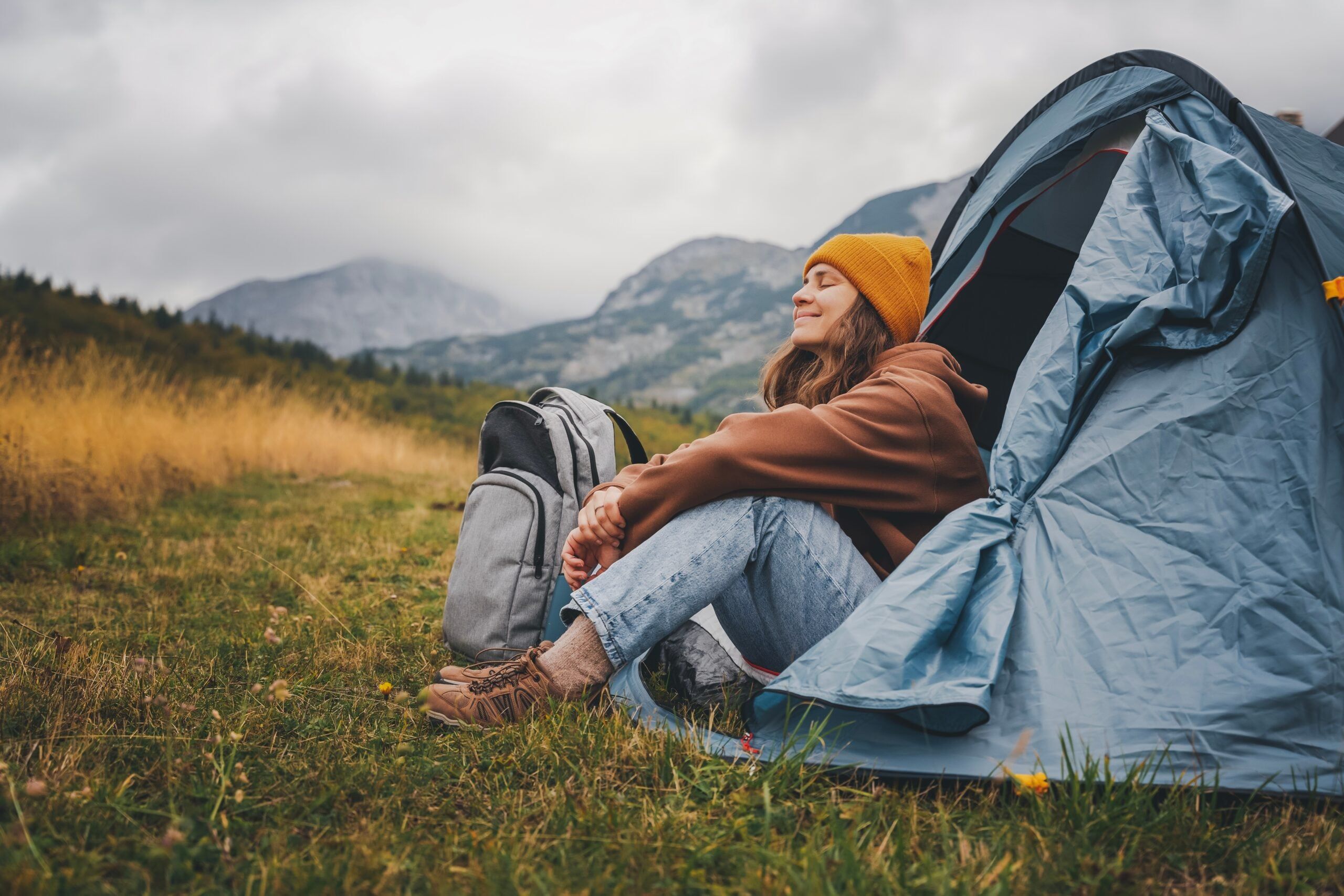 Woman camping alone in a tent.