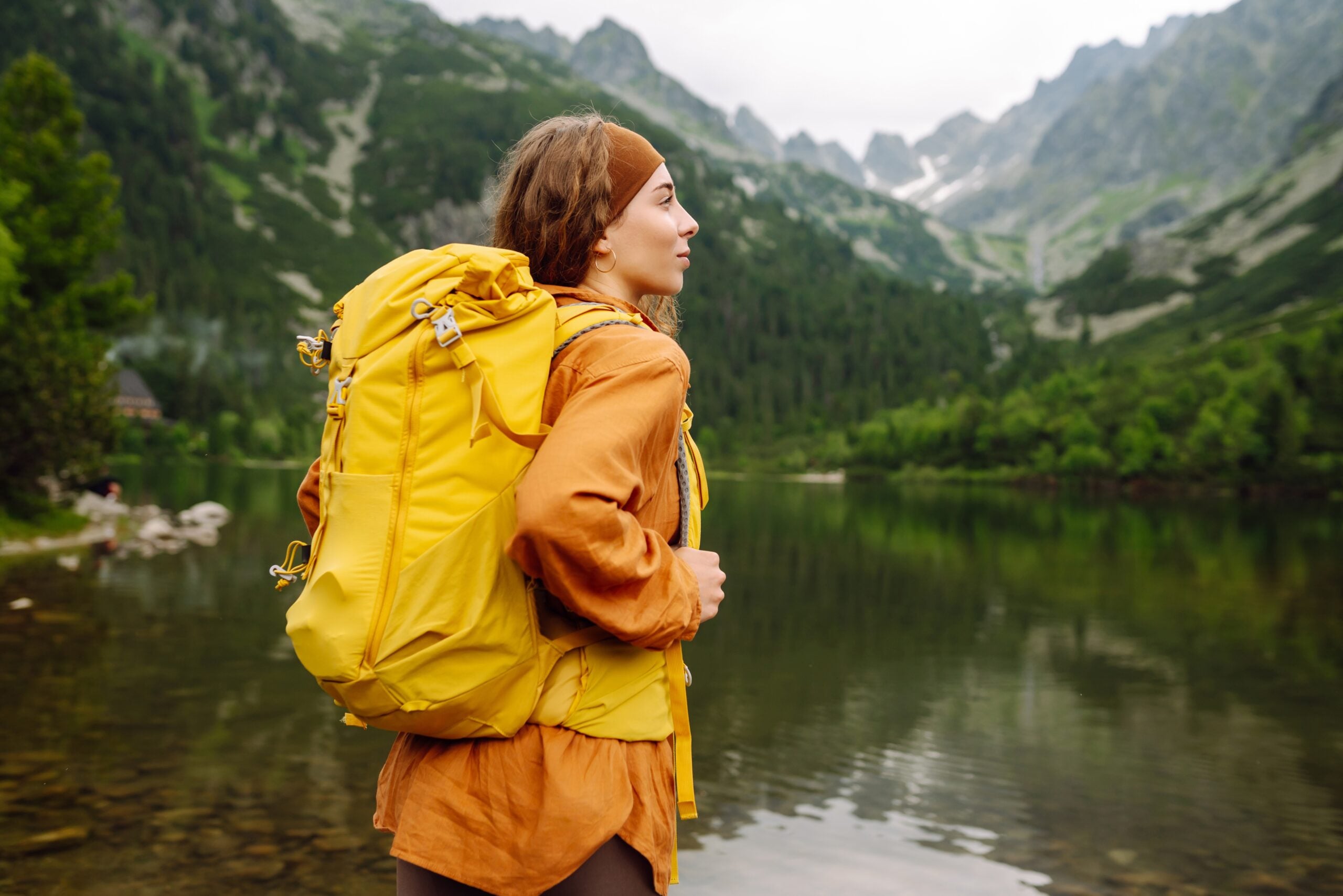 An independent woman hiking alone in the woods.