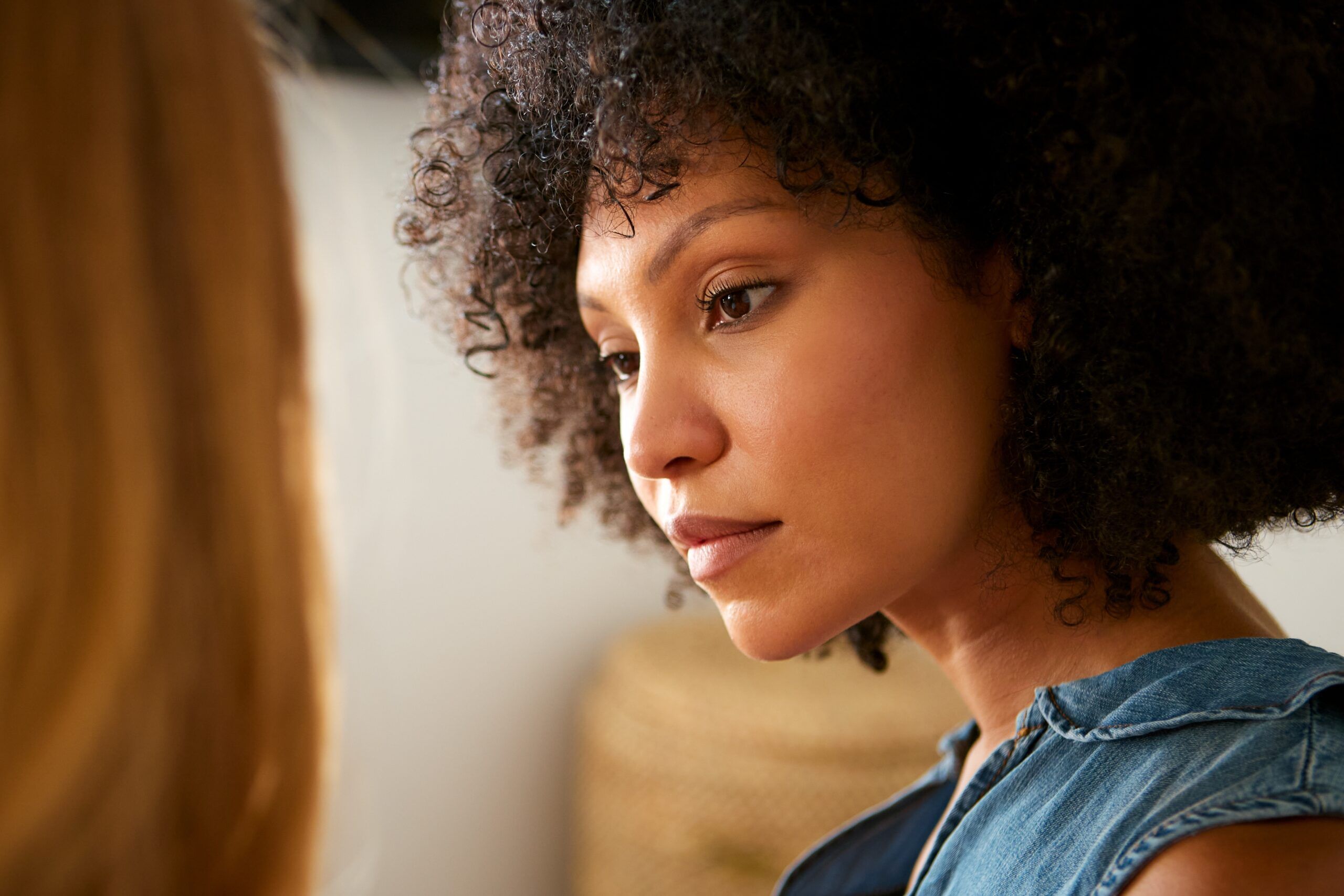 A woman in a serious conversation with her friend.