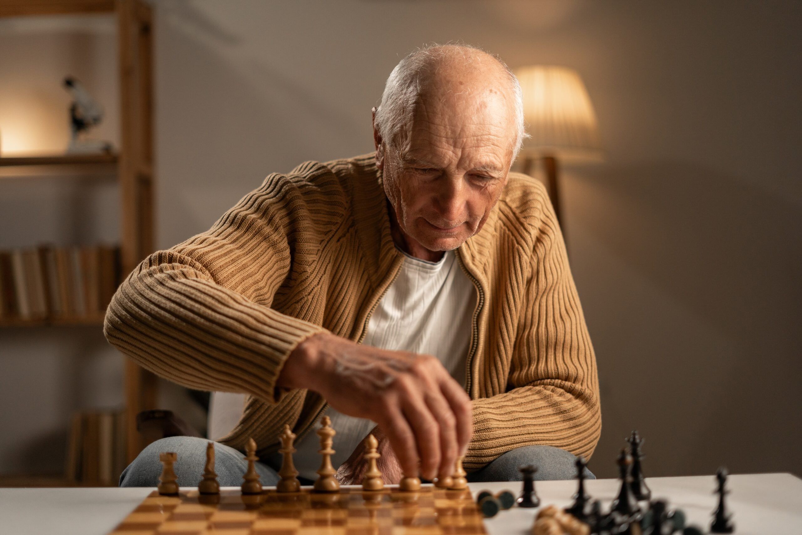 A senior man playing chess.