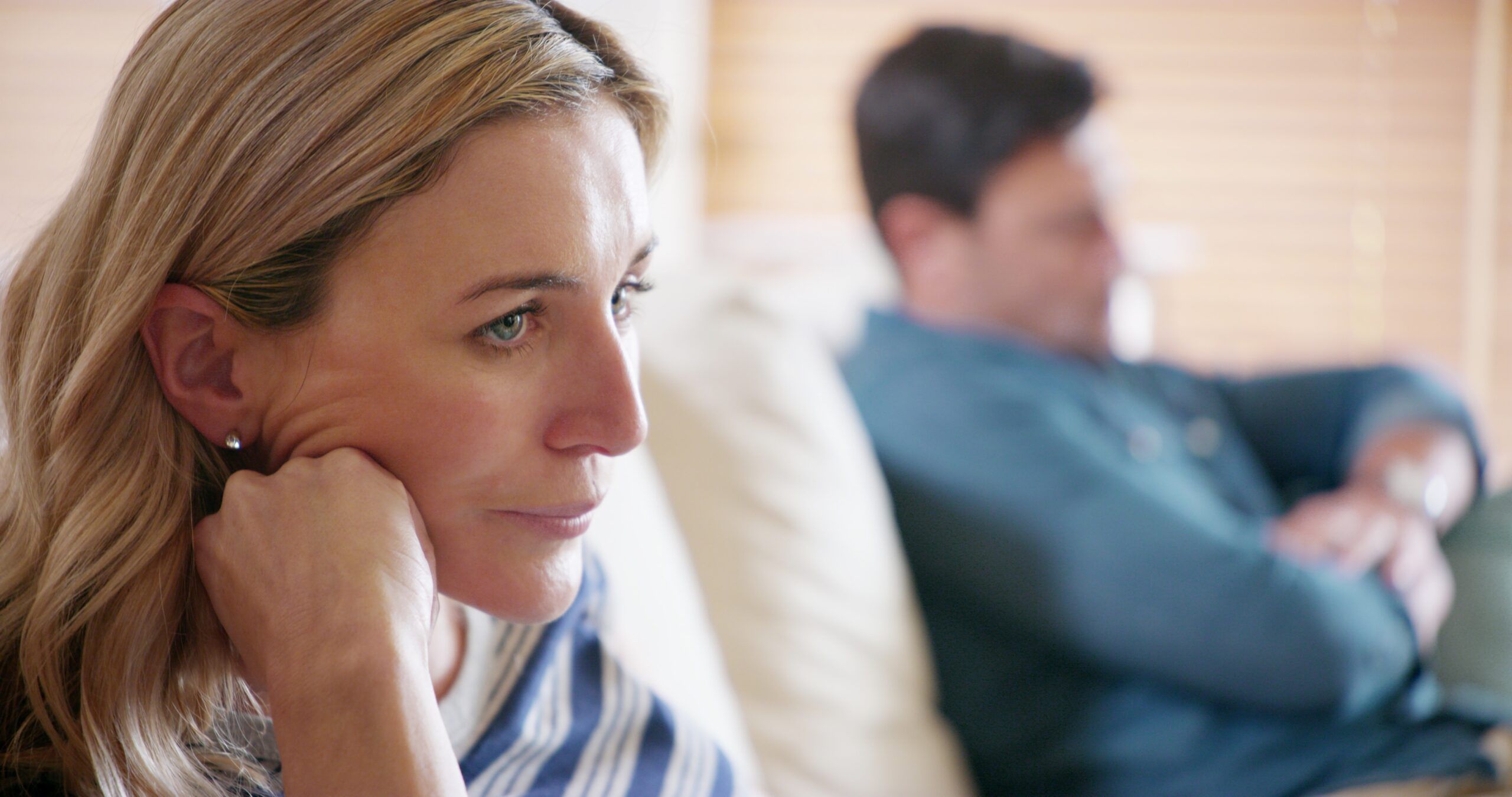 A married couple having a difficult conversation at home.