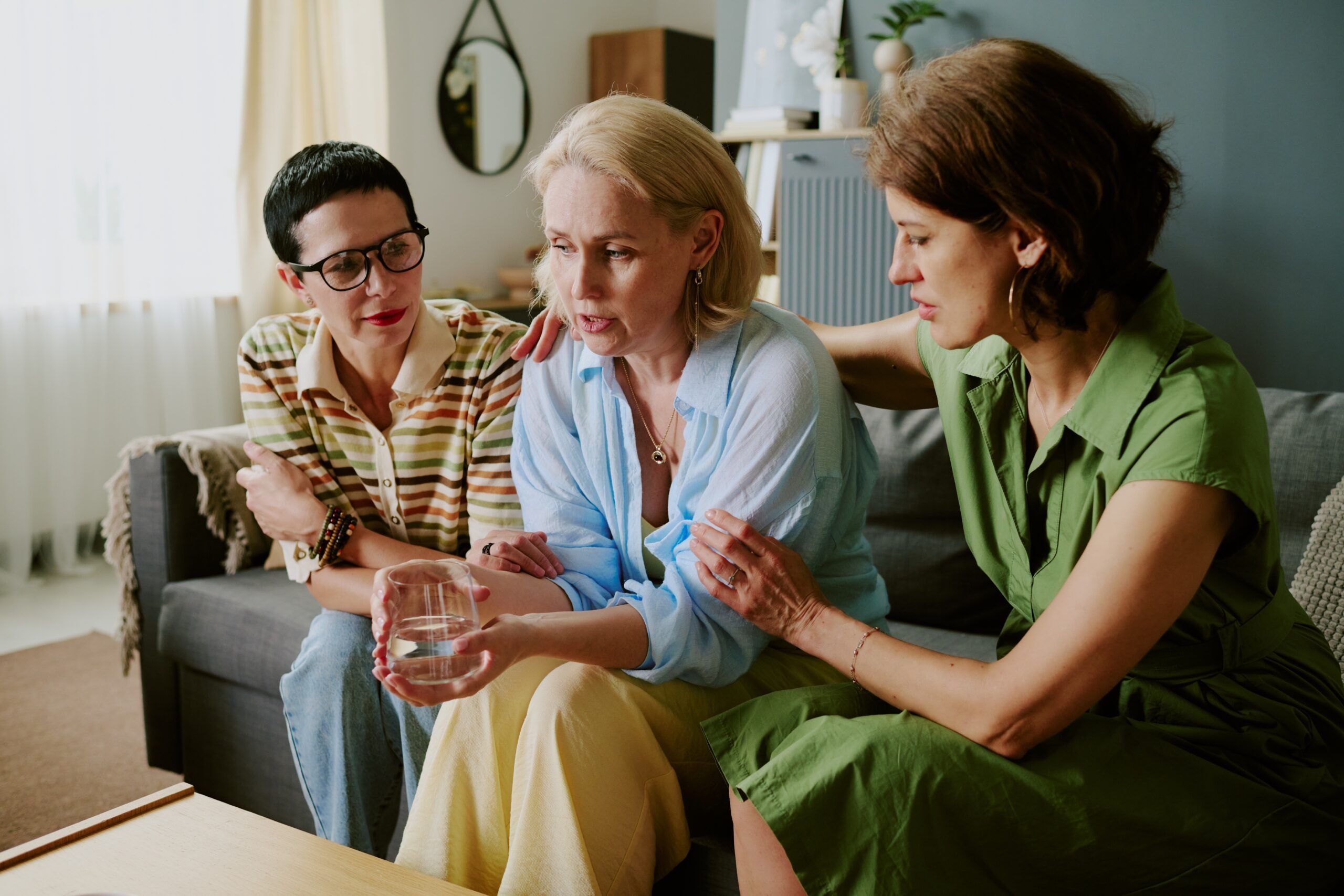 Middle aged women sitting together on the sofa.
