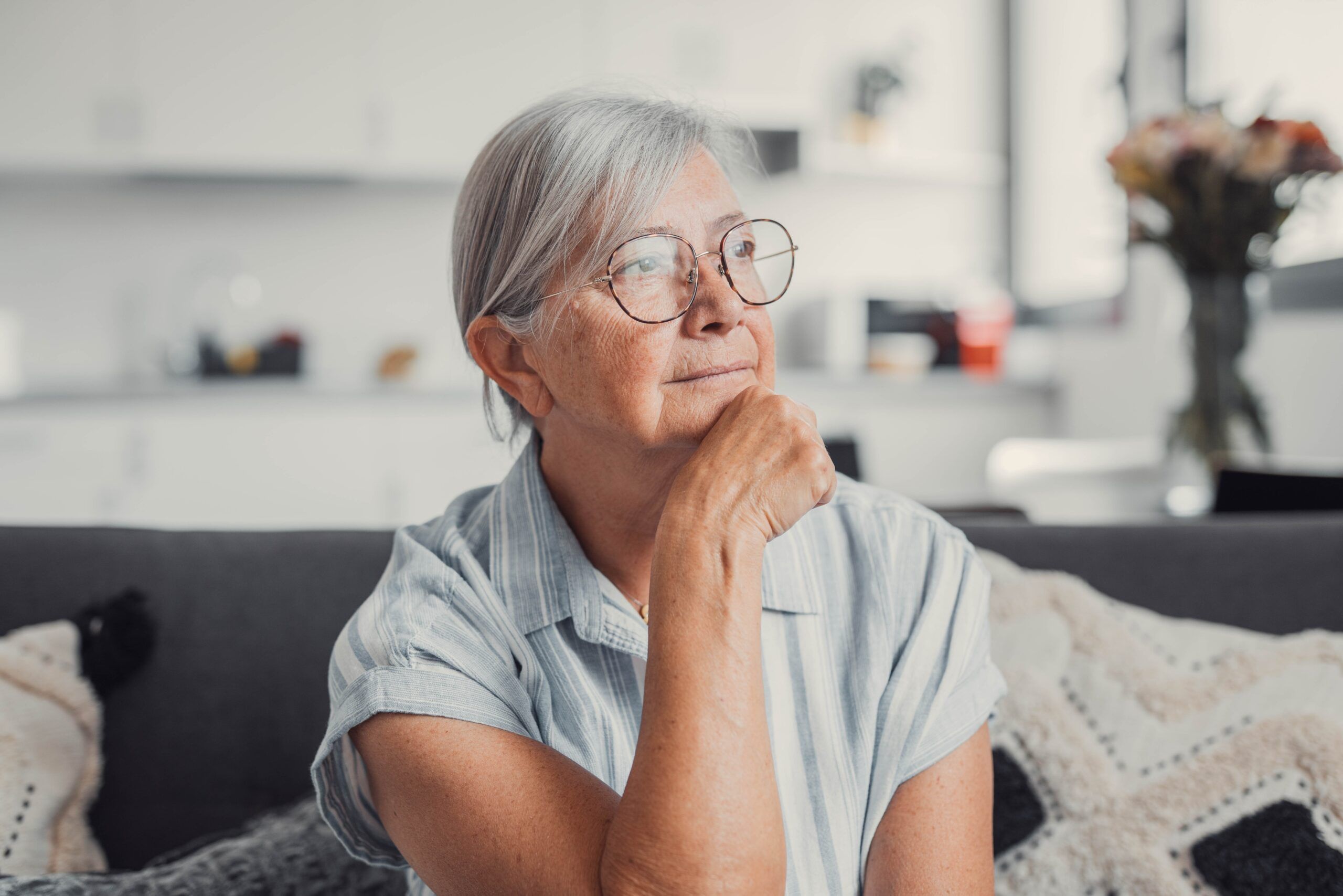 A senior woman thinking over her life's regrets.