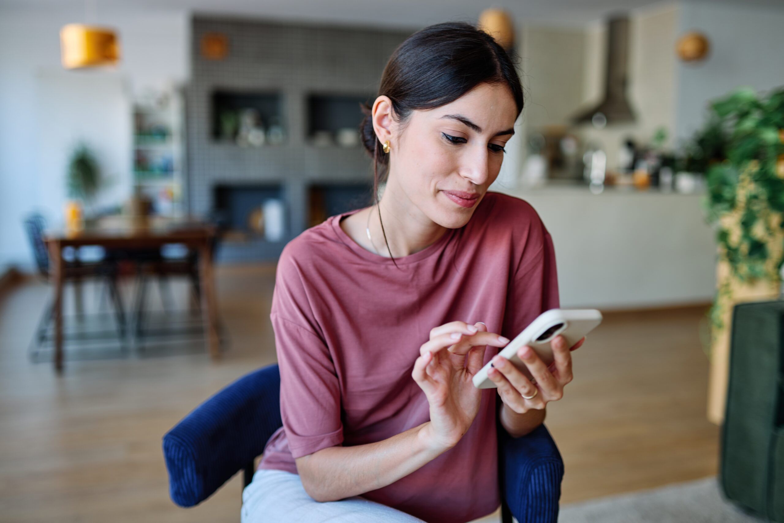 A woman scrolling through her social media.