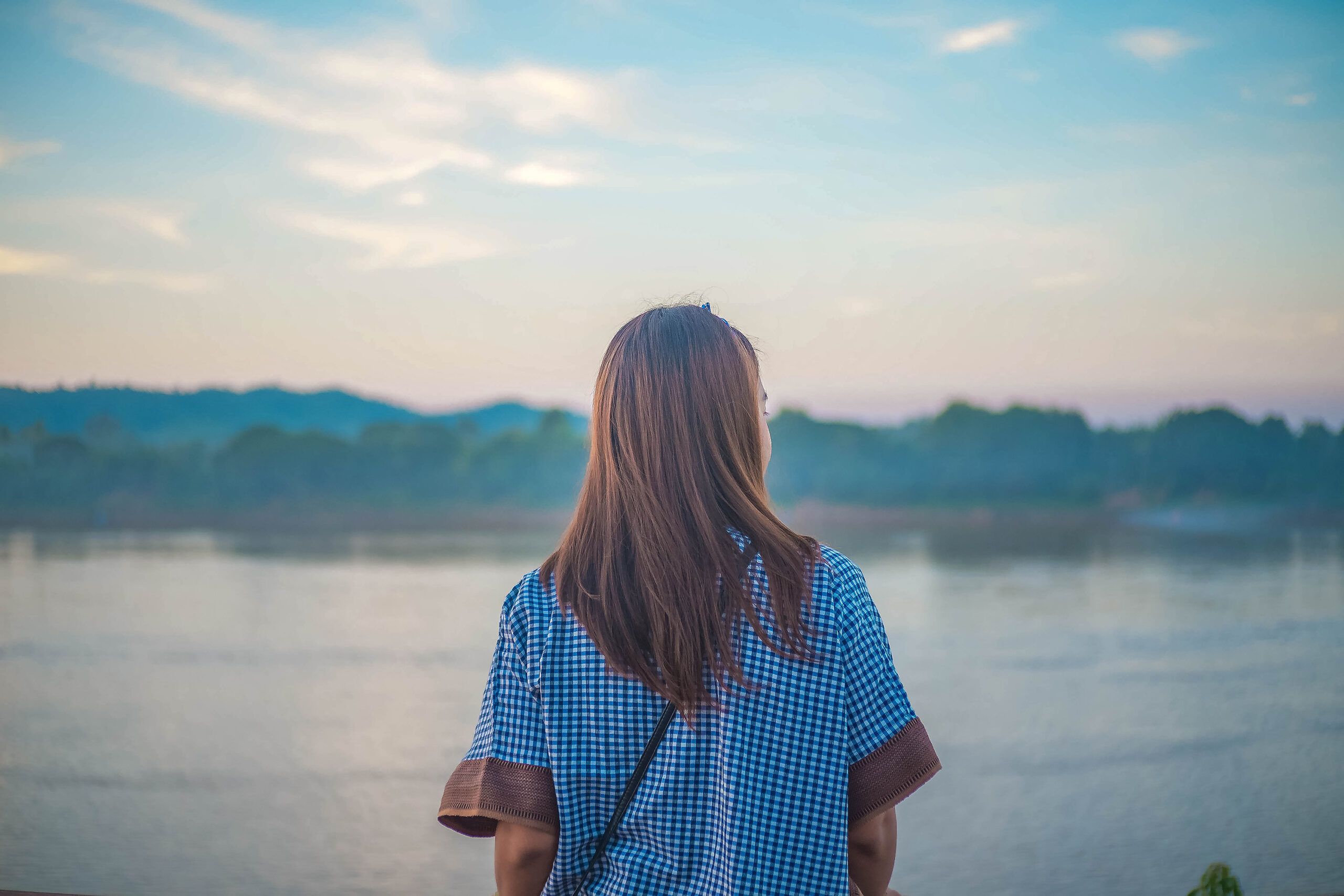 Woman solo looking at river view.