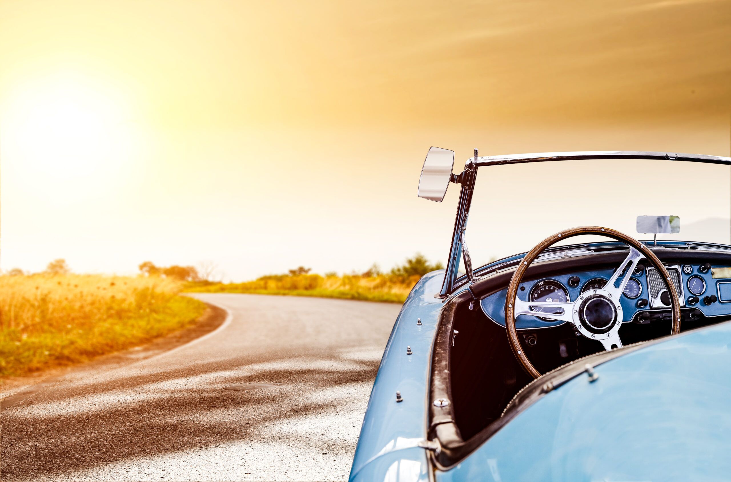 A beautiful vintage car at sunset.