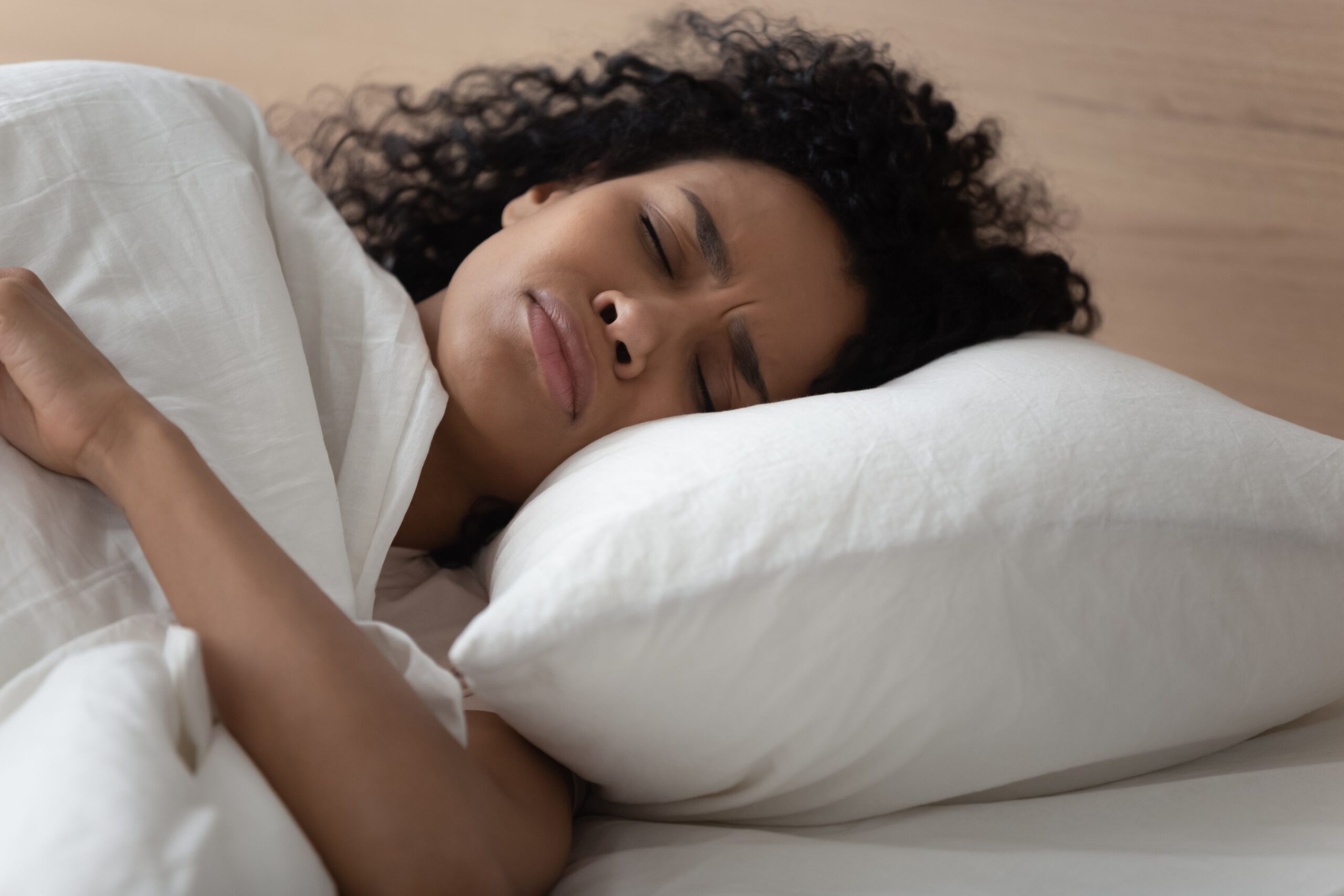 An exhausted woman unable to fall asleep.