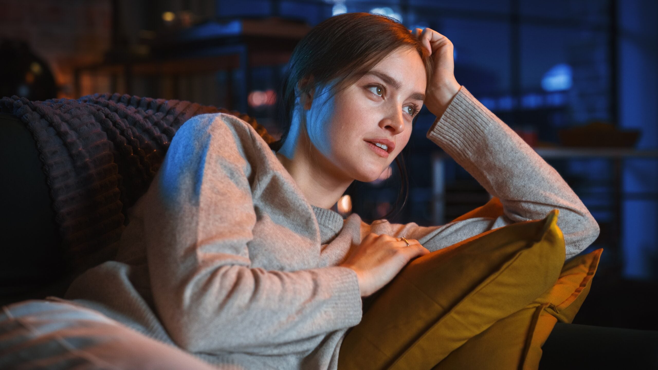 A woman watching TV alone.