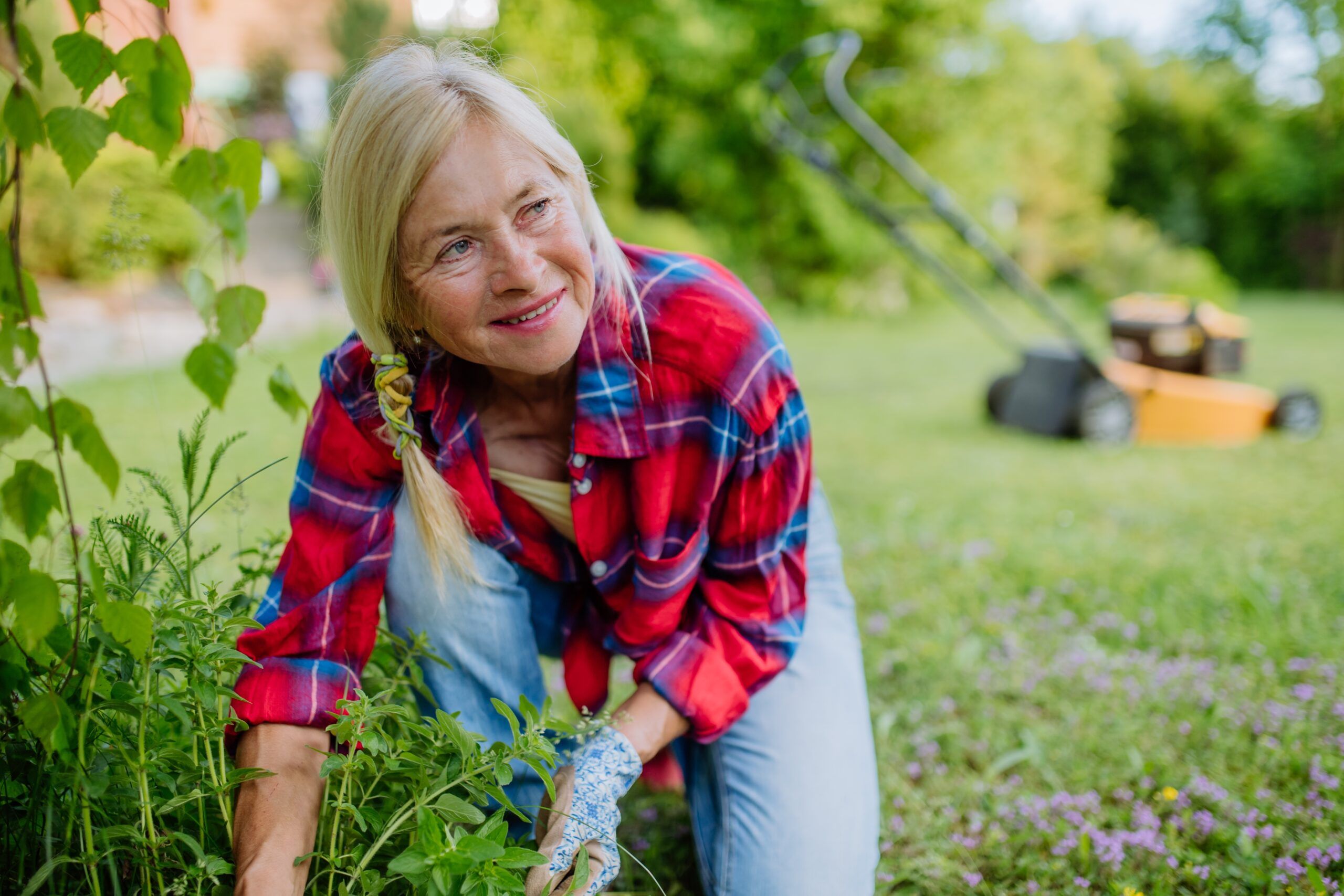 A patient midlife woman spending time in her garden.