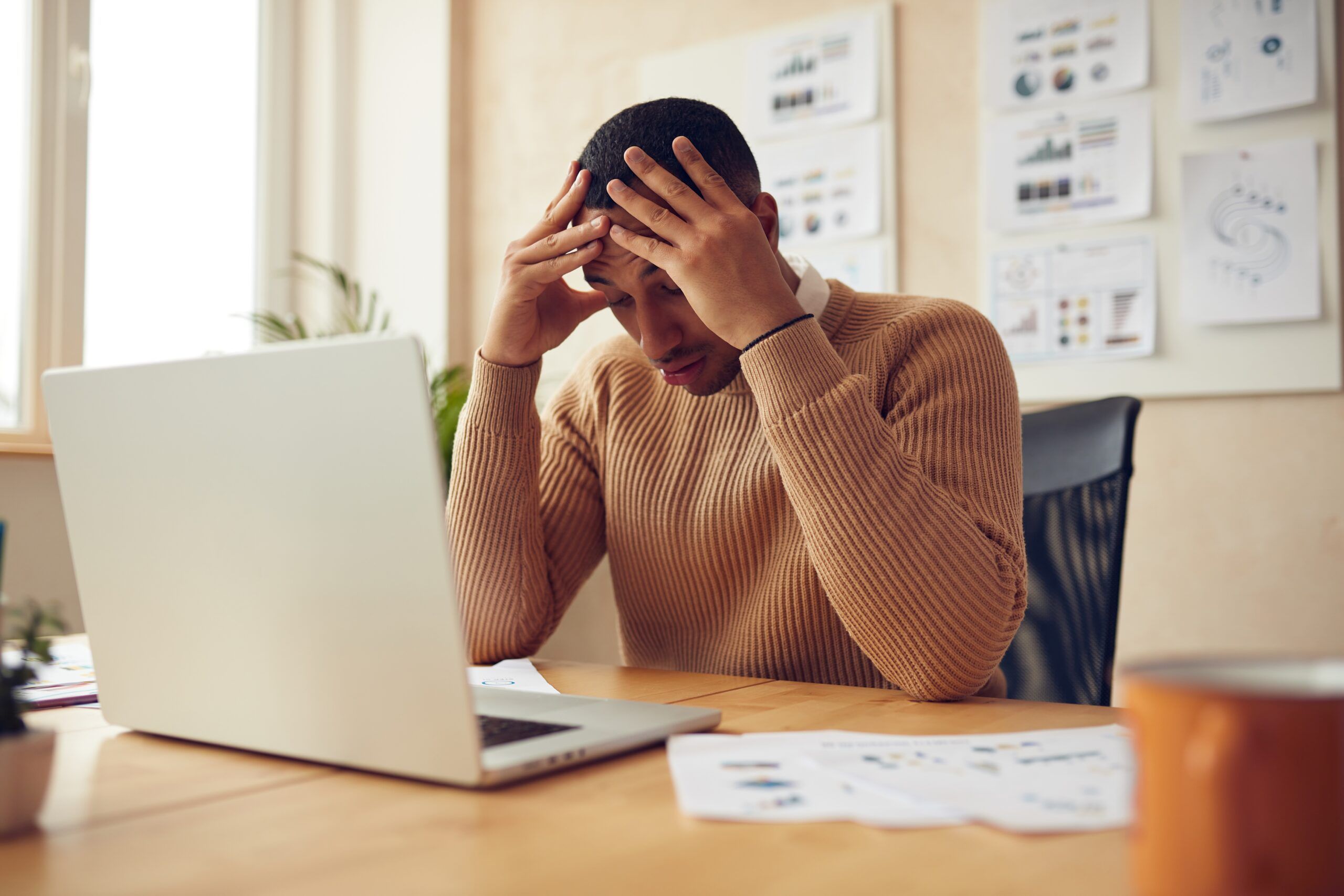 A frustrated man sitting in his office.