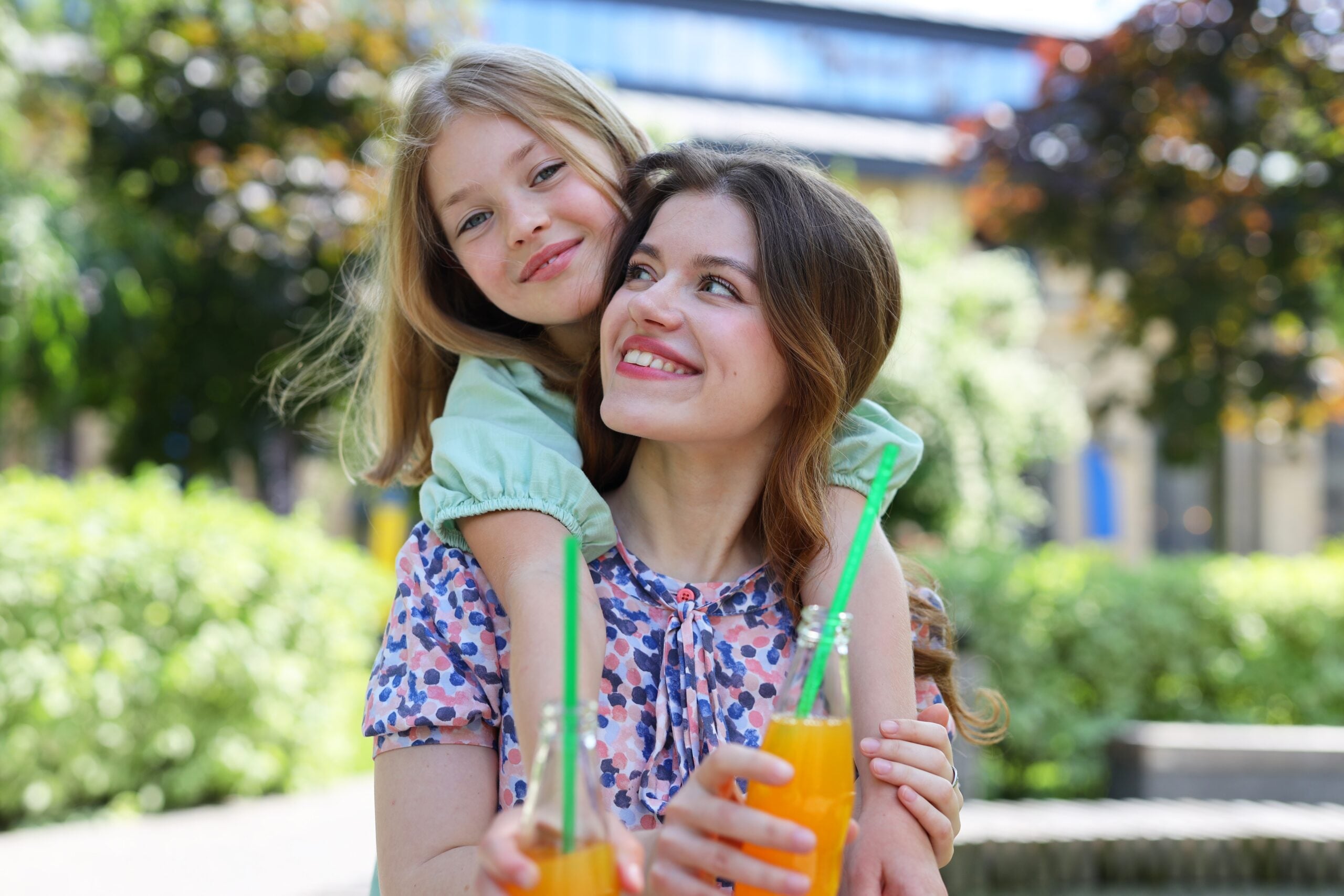 A mother enjoying time with her daughter at the park.