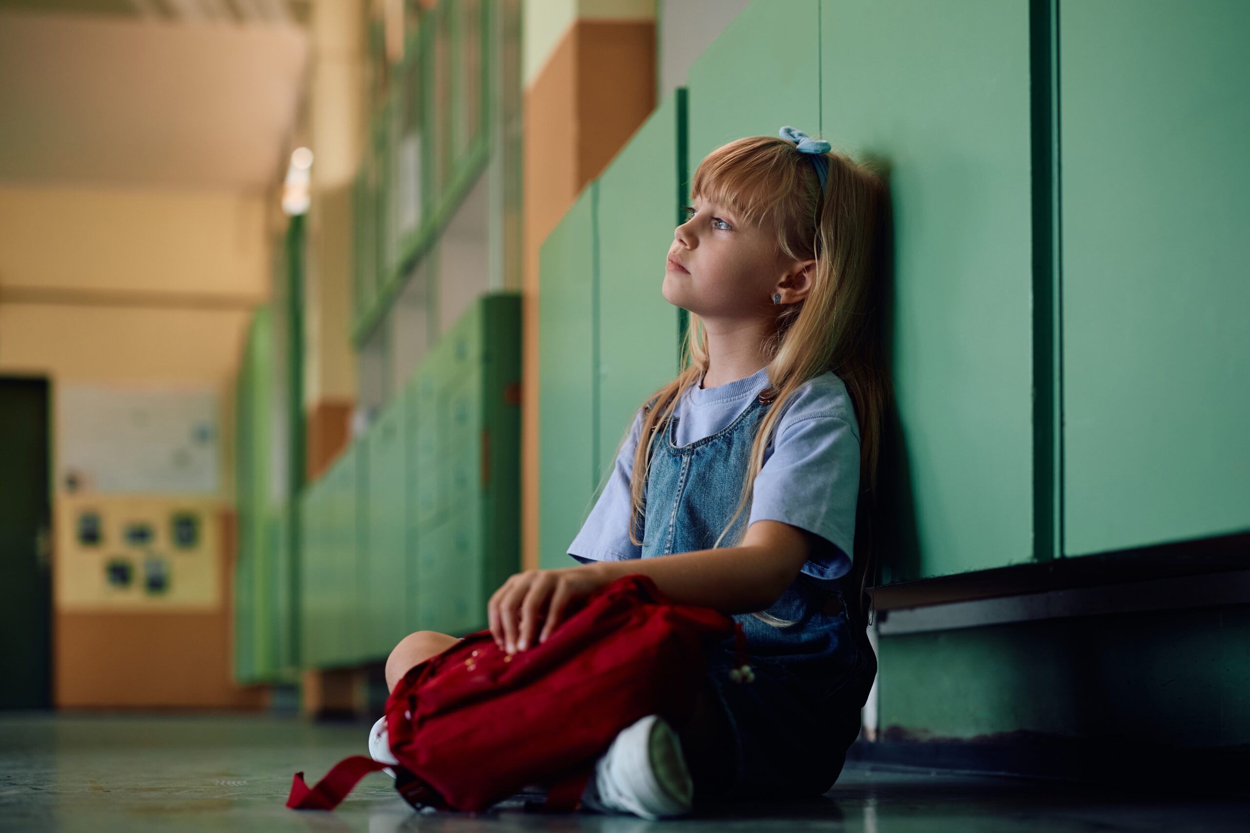 A child sitting alone at school.