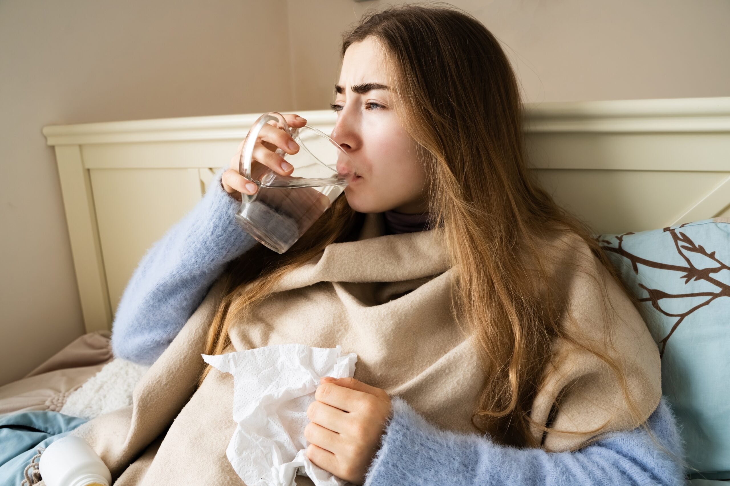 A woman home alone with the flu taking care of herself.