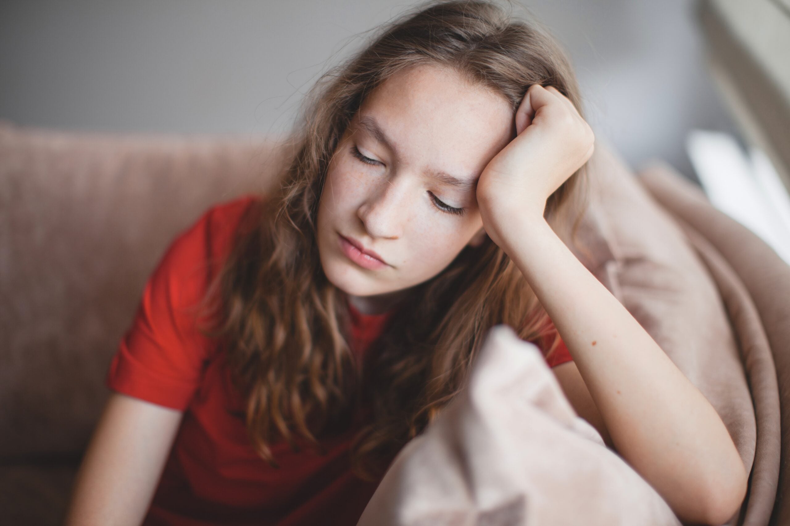 A depressed teen girl sitting alone.