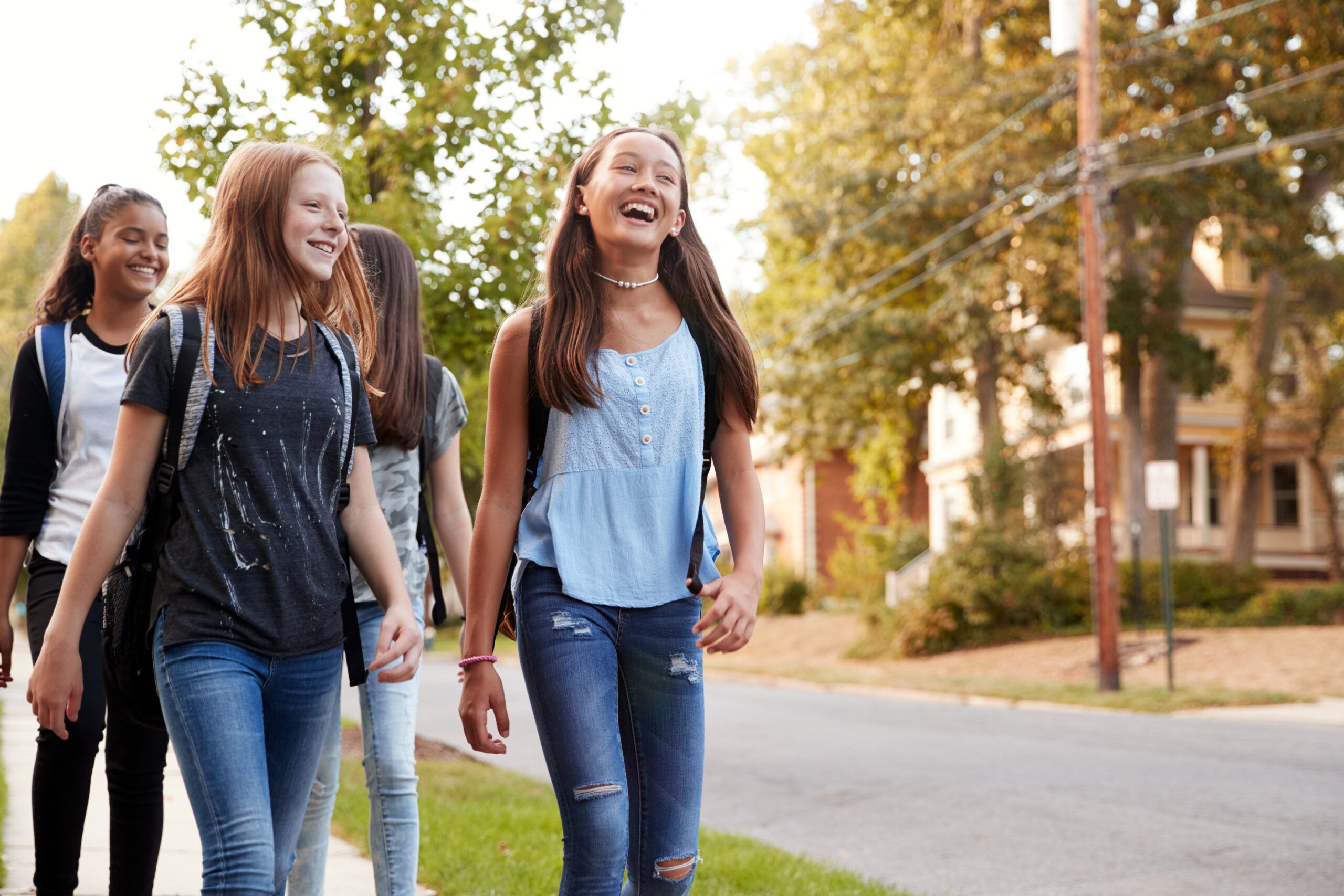 Four teenage girls on a walk home from school.