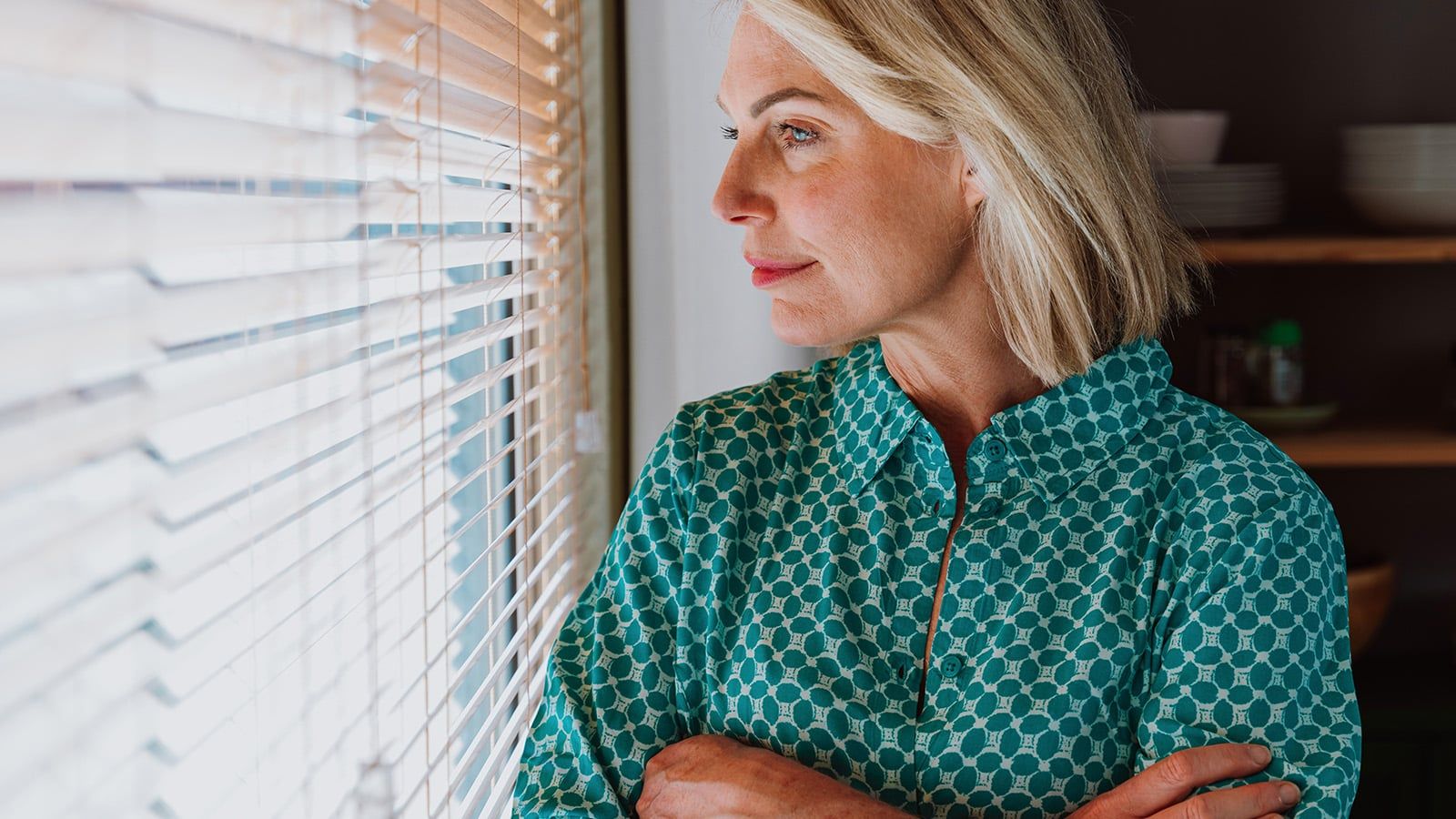 Woman looking pensively out the window.