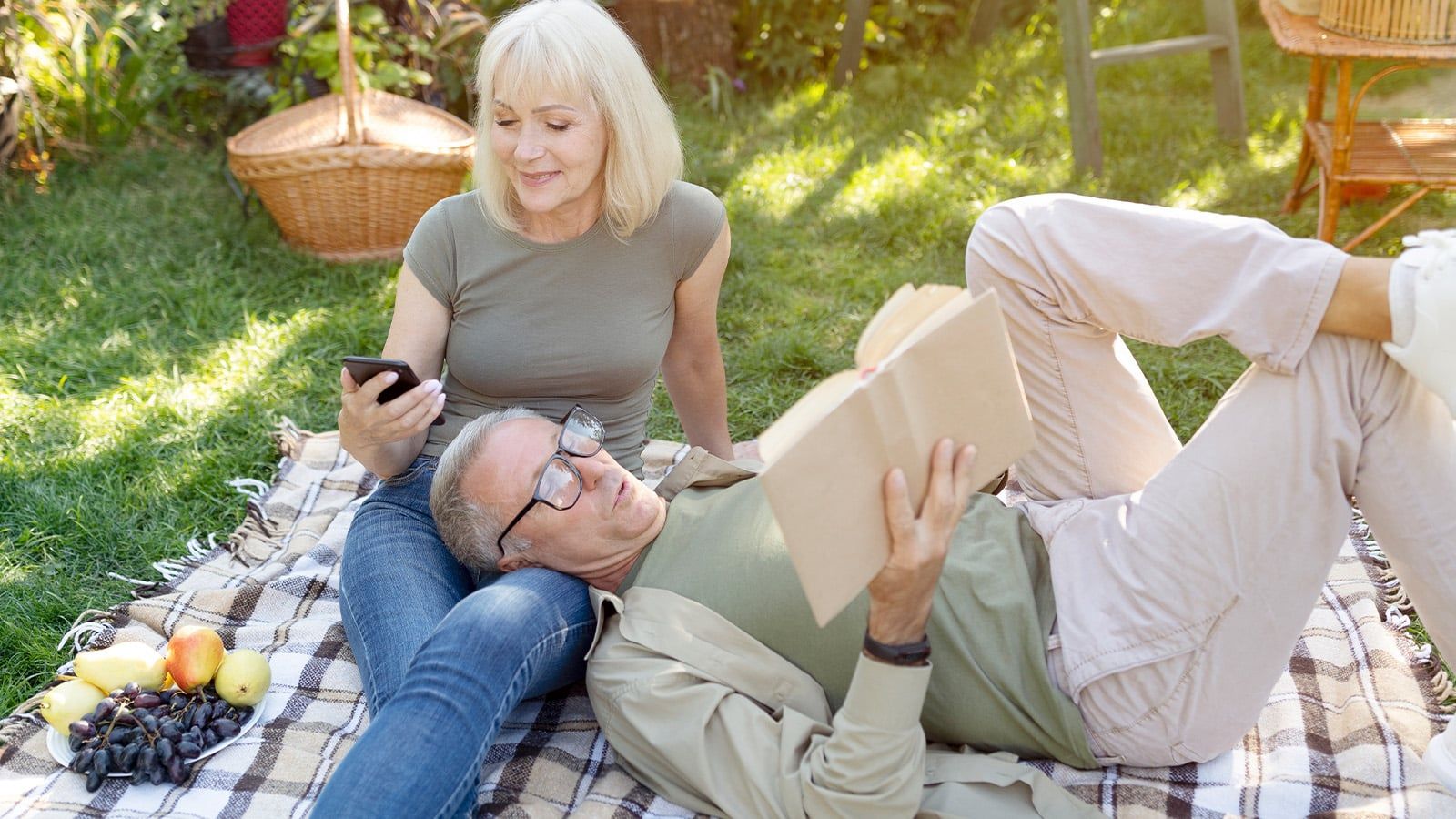 Retired couple relaxing during an afternoon picnic on a weekday.