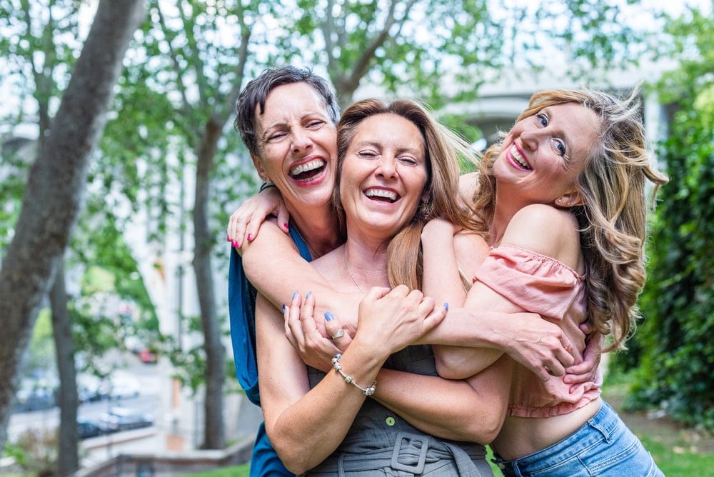 A group of three happy and cheerful mature middle age female friends