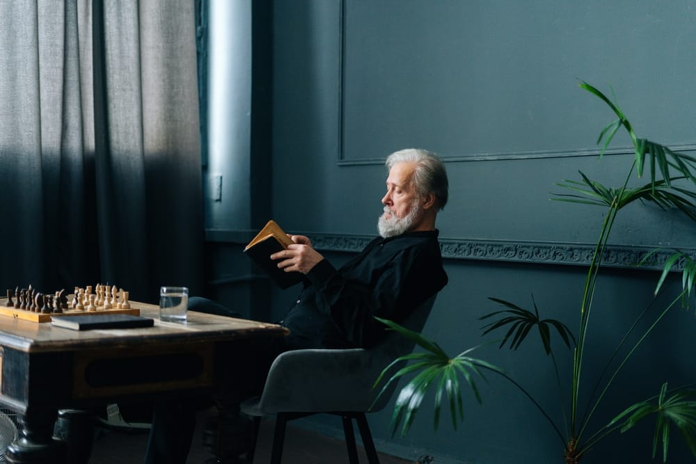 A senior male reading a paperback
