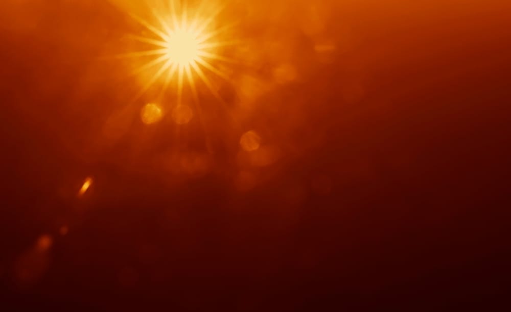 A burst of sunshine in an orange sky.