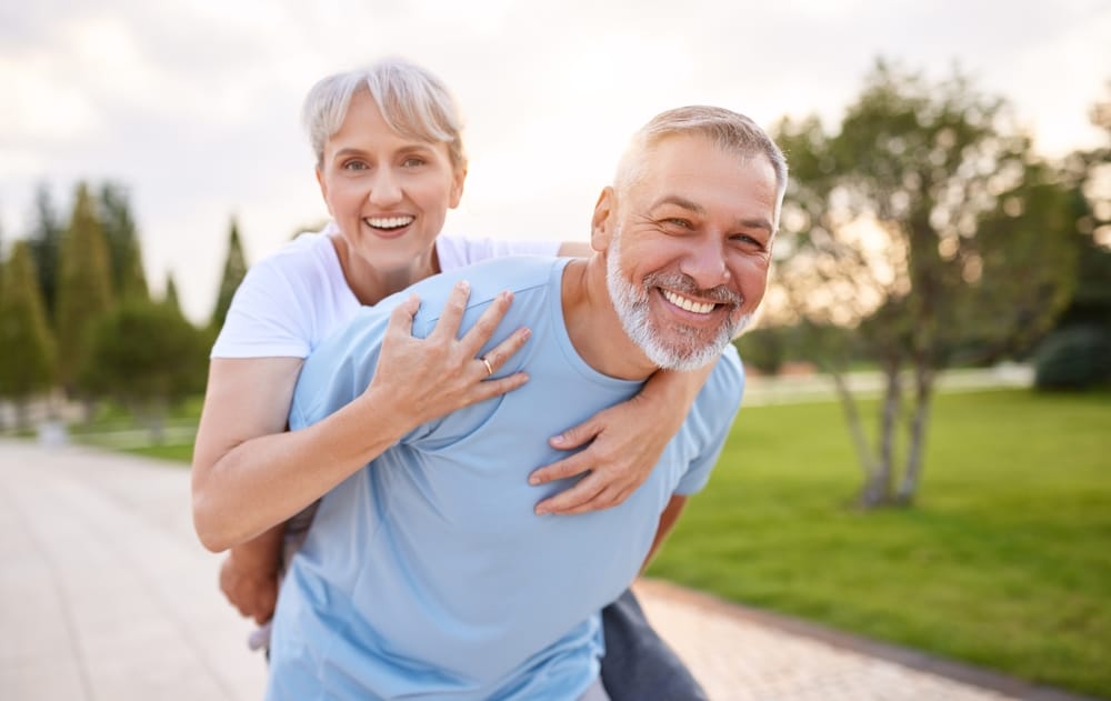Older man and woman laughing together.