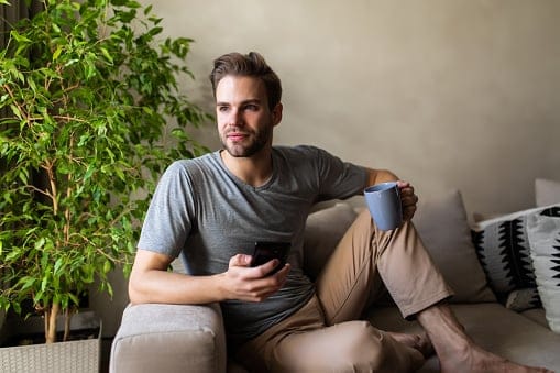 guy sitting on couch in apartment