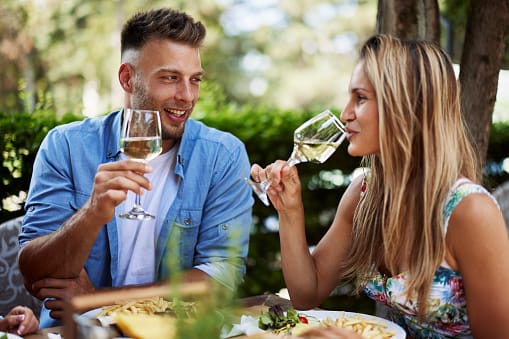 Young couple enjoy lunch at a restaurant and drink wine