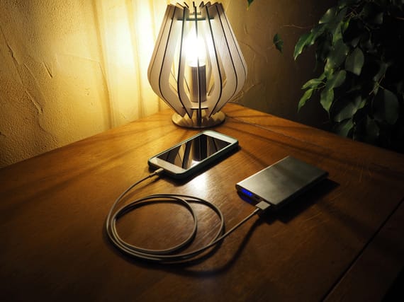 The mobile is charging with a power-bank. You can use a power-bank everywhere, at home or when you travel.
